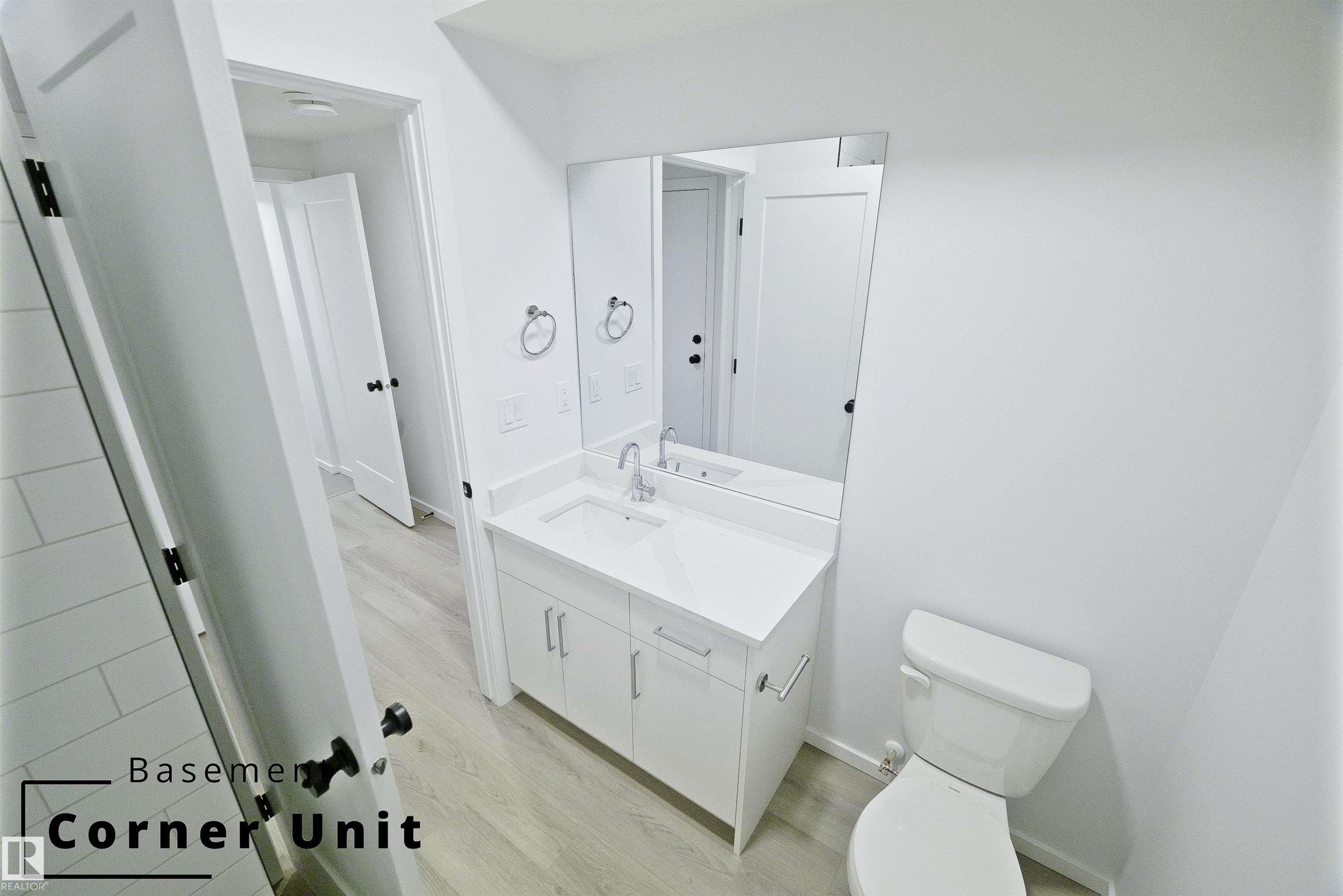 Half bathroom featuring vanity and light wood finished floors - 7585 174A Avenue, Edmonton, AB - Indoor Photo Showing Bathroom