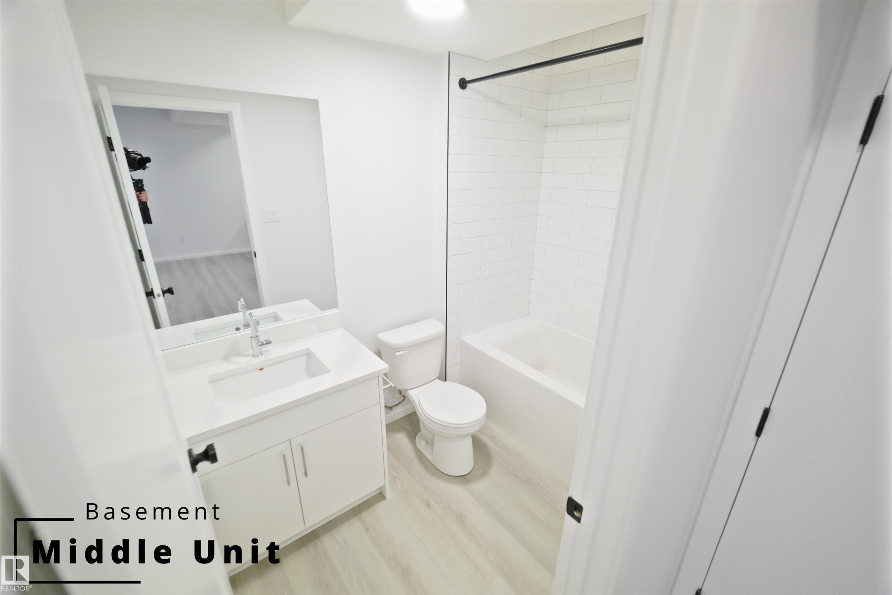 Bathroom with vanity, tub / shower combination, and light wood finished floors - 7585 174A Avenue, Edmonton, AB - Indoor Photo Showing Bathroom