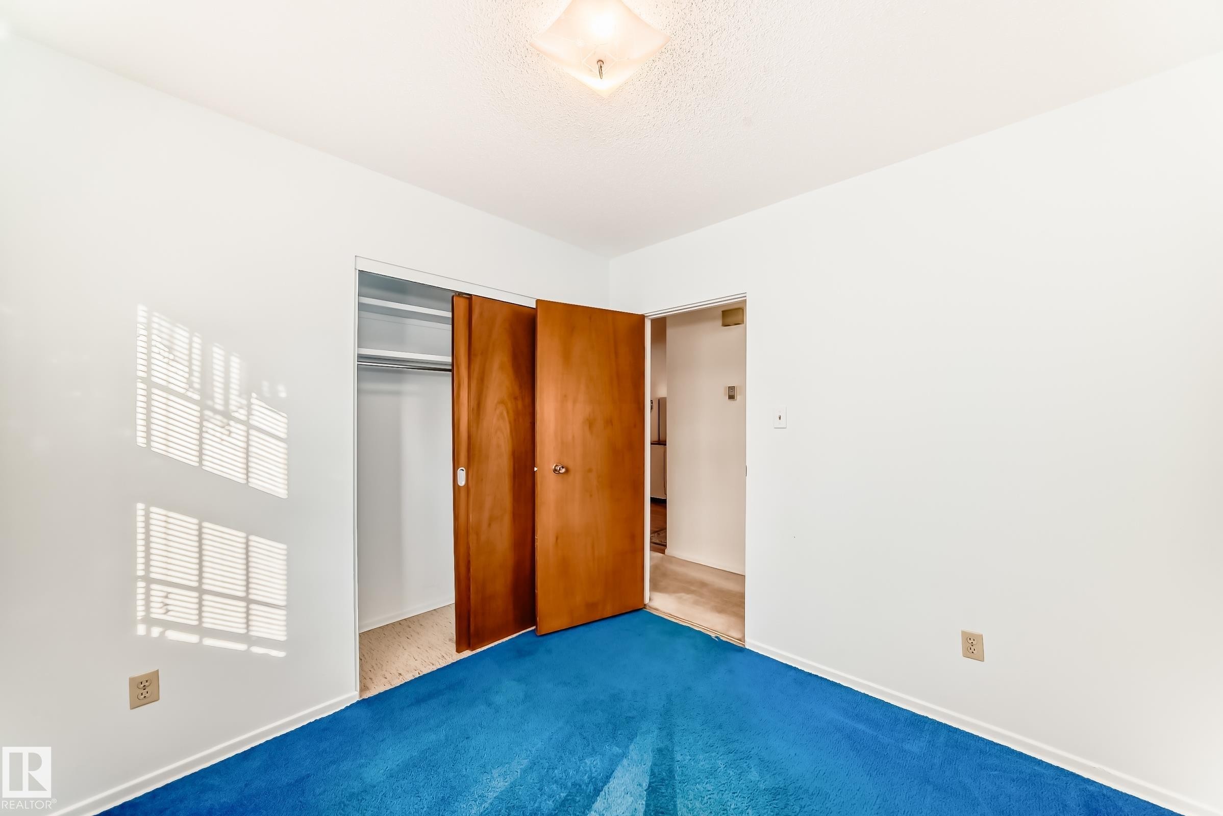 Unfurnished bedroom featuring carpet floors and a closet - Edmonton, AB - Indoor Photo Showing Other Room