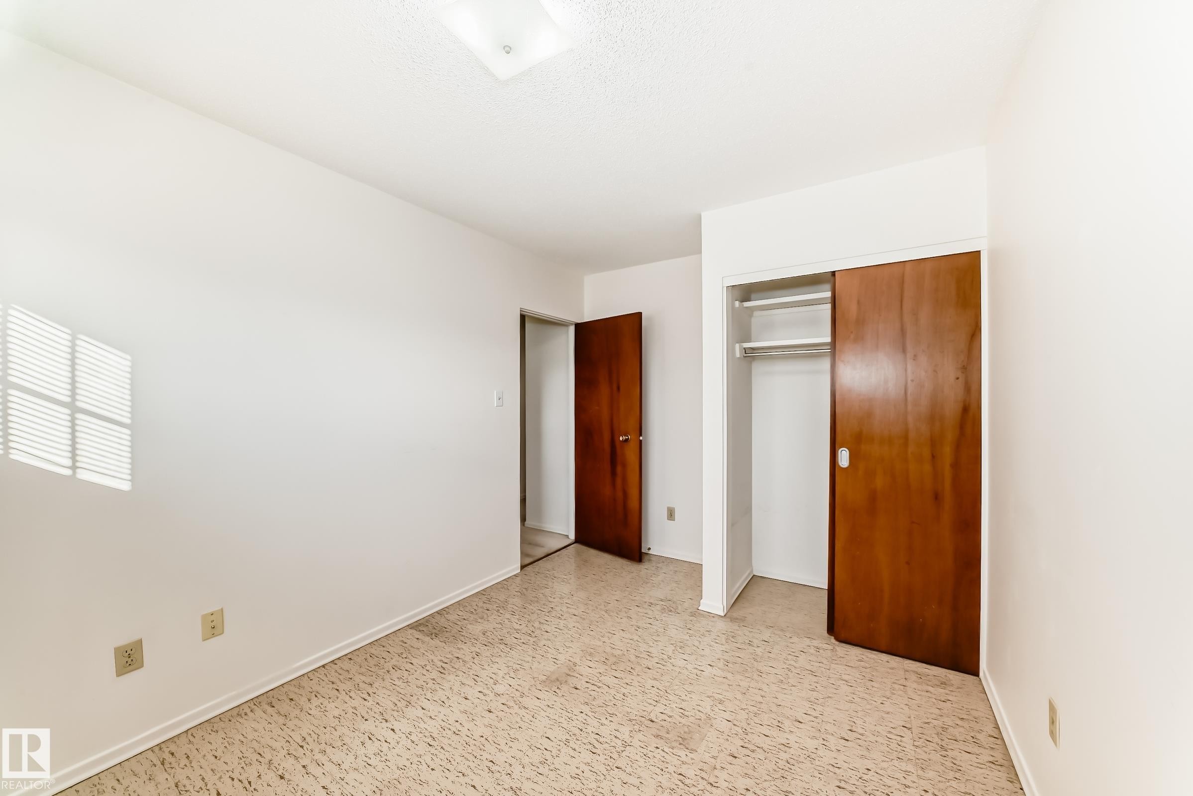Unfurnished bedroom with a closet and baseboards - Edmonton, AB - Indoor Photo Showing Other Room