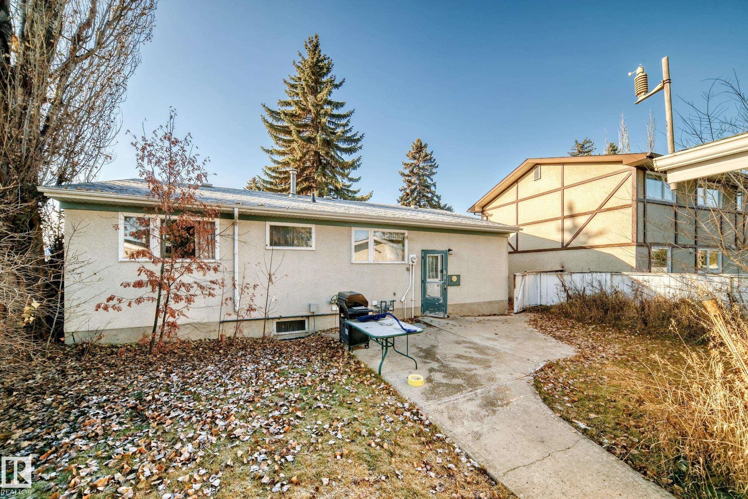 Rear view of house with a patio area and stucco siding - Edmonton, AB - Outdoor