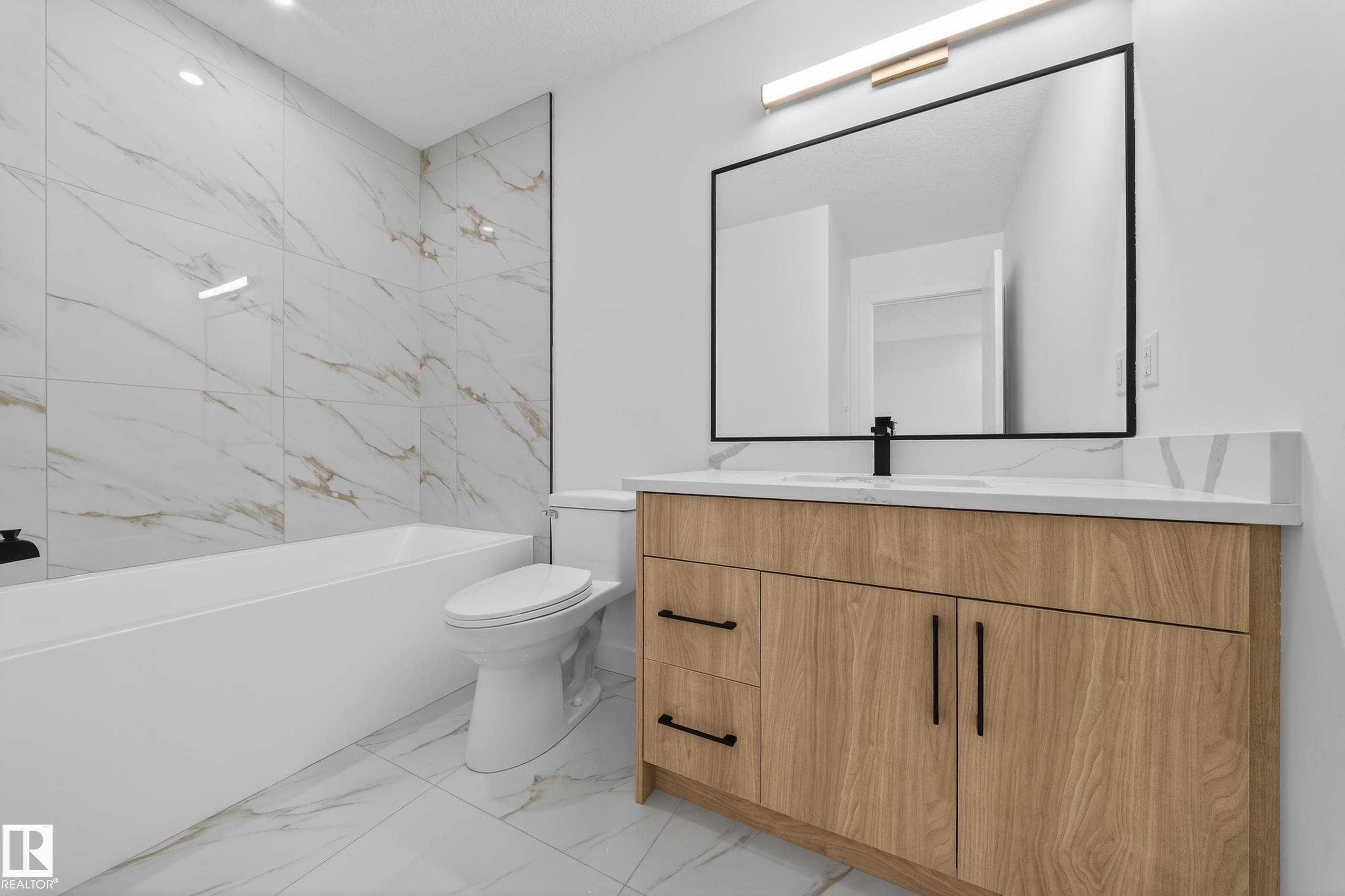 Full bath with vanity, light marble finish flooring, and shower / bath combination - 129 Pierwyck Loop, Spruce Grove, AB - Indoor Photo Showing Bathroom