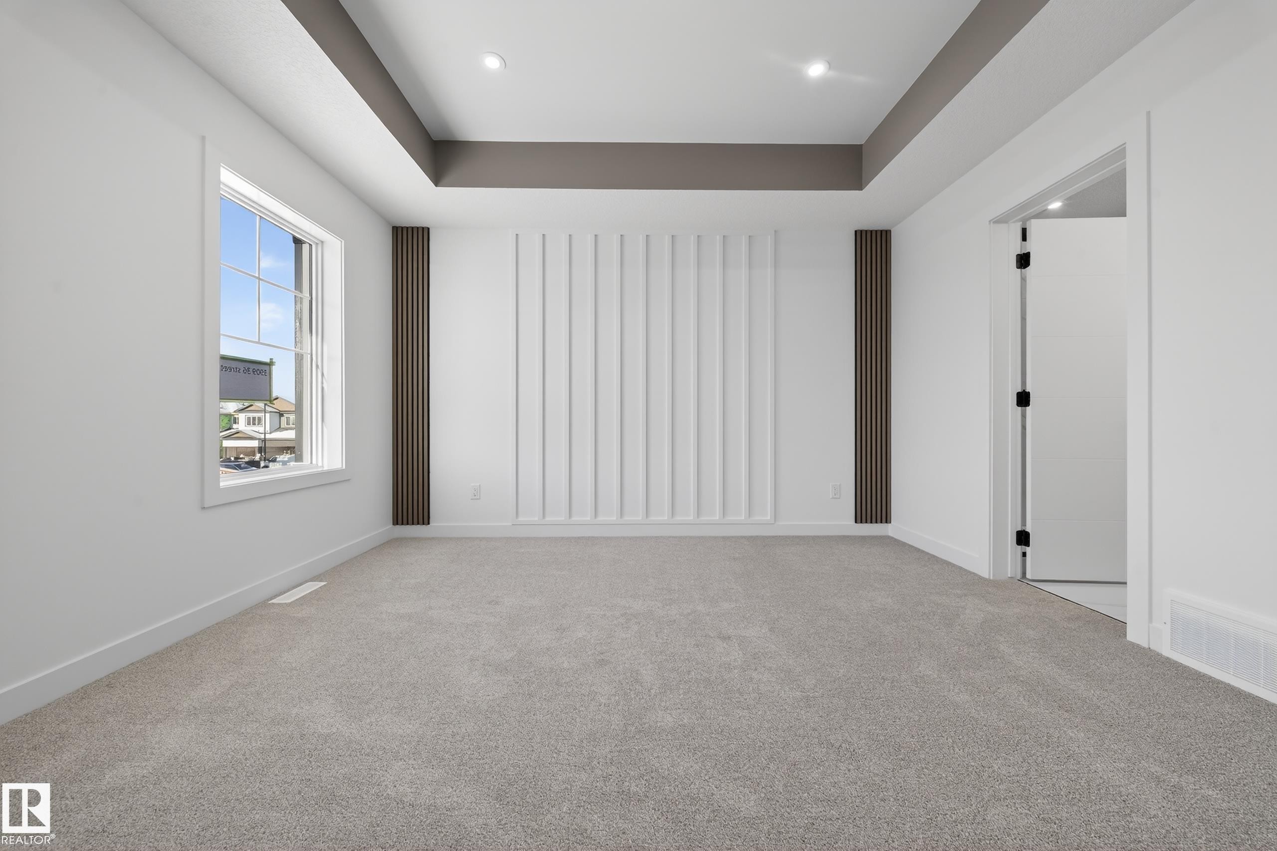 Spare room featuring a tray ceiling and carpet - 129 Pierwyck Loop, Spruce Grove, AB - Indoor Photo Showing Other Room