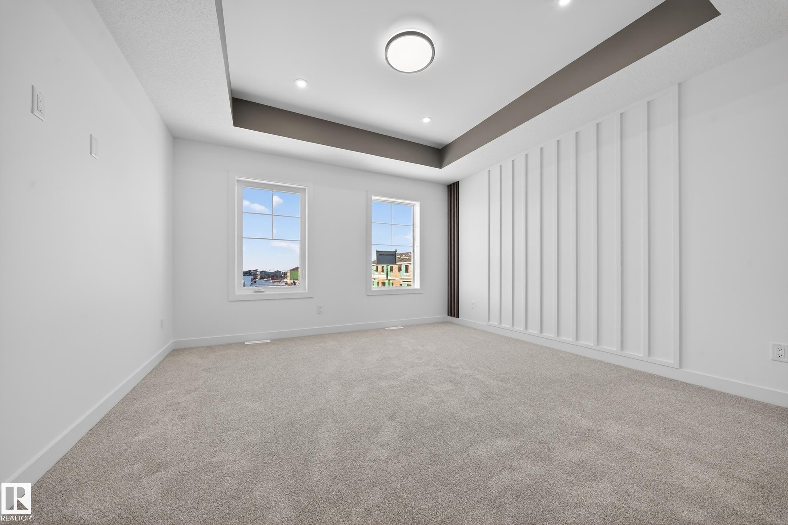 Carpeted spare room featuring a tray ceiling and recessed lighting - 129 Pierwyck Loop, Spruce Grove, AB - Indoor Photo Showing Other Room