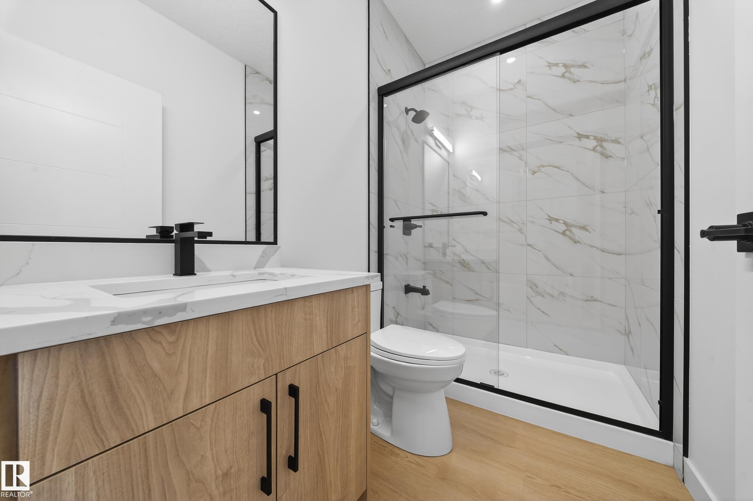 Full bathroom with vanity, a marble finish shower, and light wood-style floors - 129 Pierwyck Loop, Spruce Grove, AB - Indoor Photo Showing Bathroom