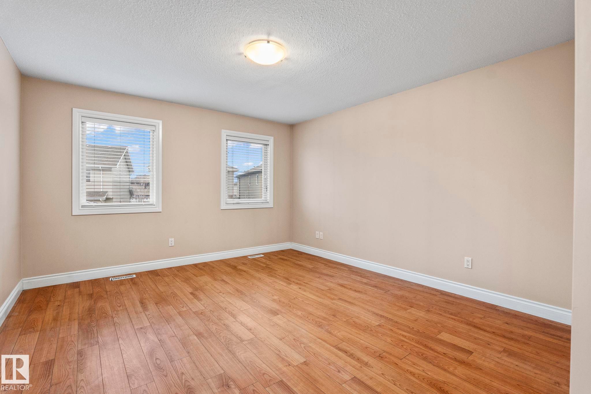 Unfurnished room featuring a textured ceiling and light wood-type flooring - 1888 33 Street, Edmonton, AB - Indoor Photo Showing Other Room