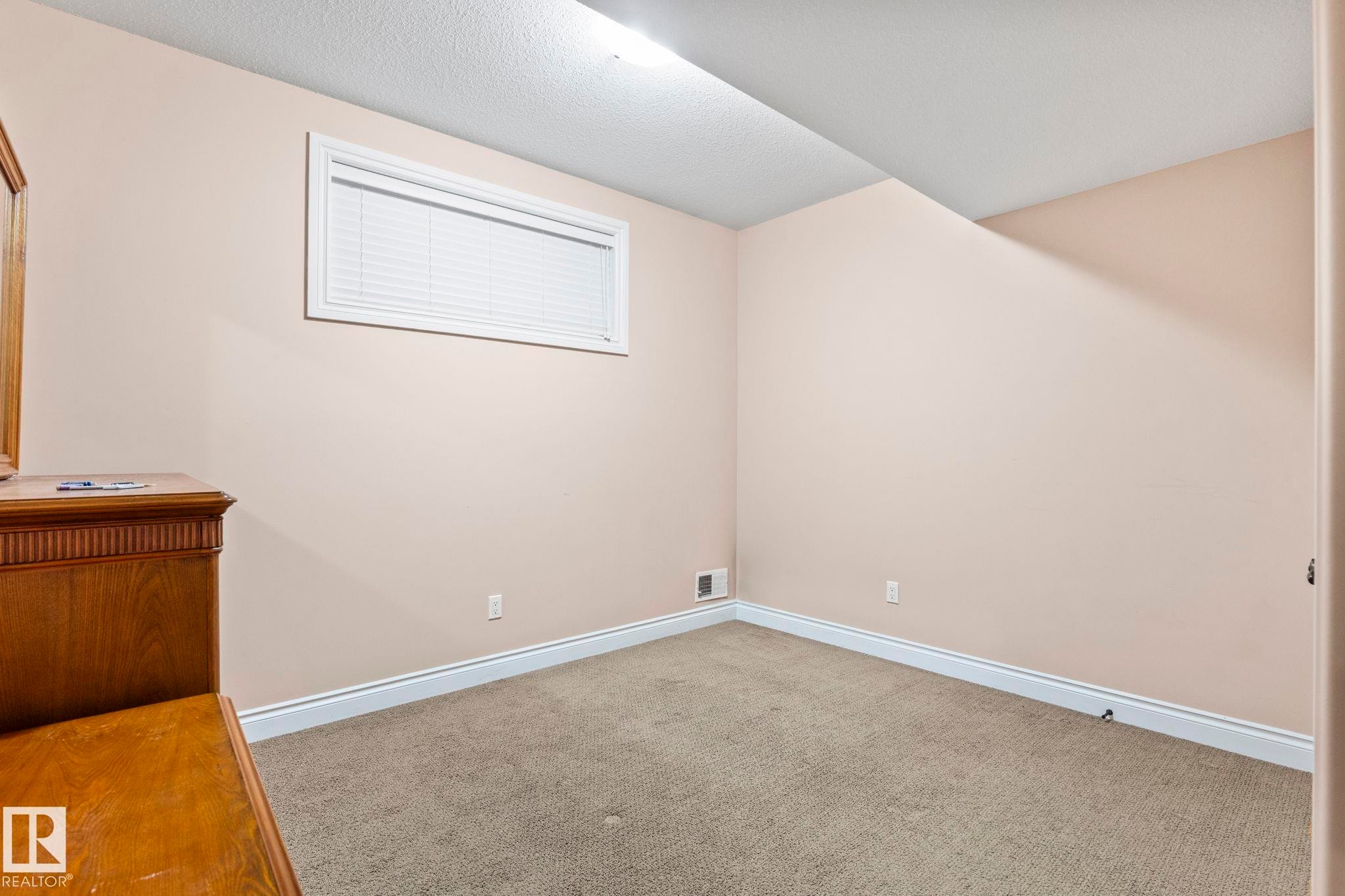 Spare room with carpet and a textured ceiling - 1888 33 Street, Edmonton, AB - Indoor Photo Showing Other Room