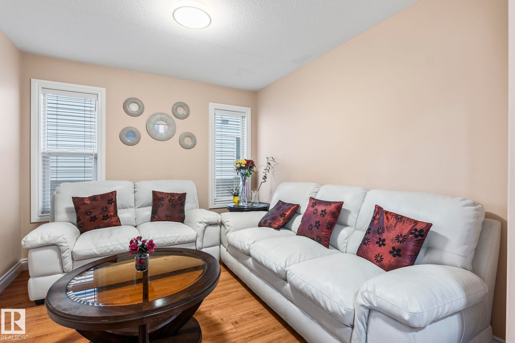 Living area with wood finished floors and a textured ceiling - 1888 33 Street, Edmonton, AB - Indoor Photo Showing Living Room