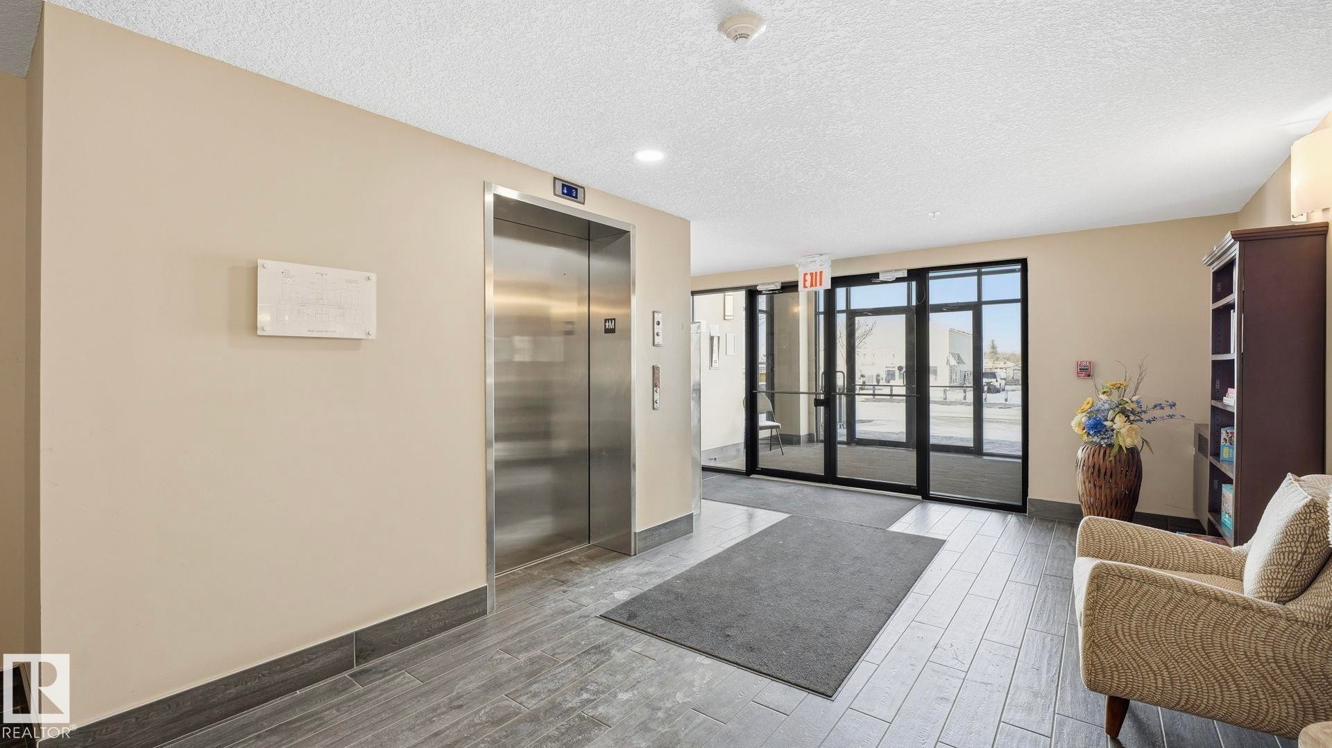 Building lobby with a textured ceiling and recessed lighting - 401 17 Columbia Avenue W, Devon, AB - Indoor Photo Showing Other Room