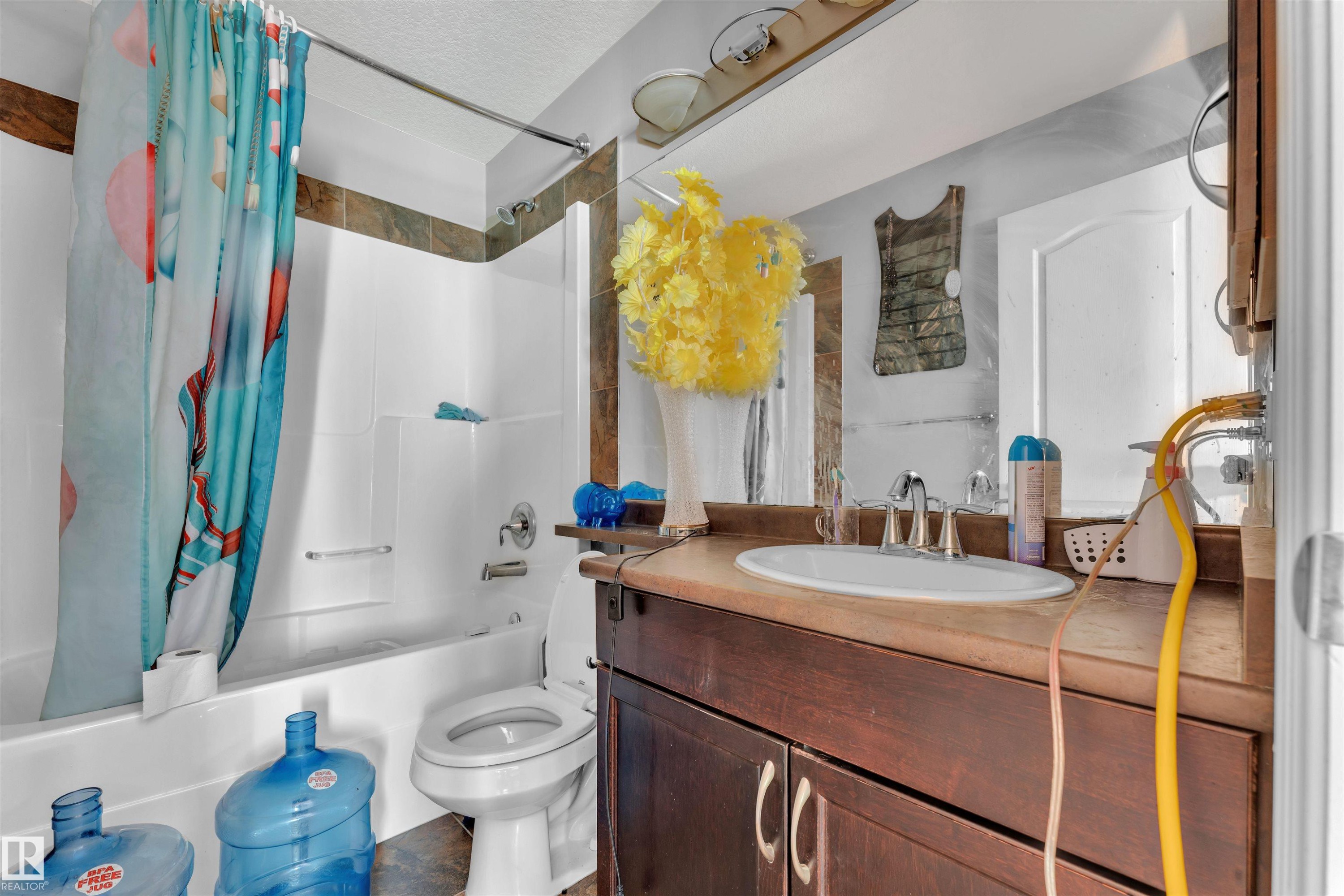 Bathroom featuring shower / bath combo, vanity, and a textured ceiling - 3015 26 Ave Nw, Edmonton, AB - Indoor Photo Showing Bathroom