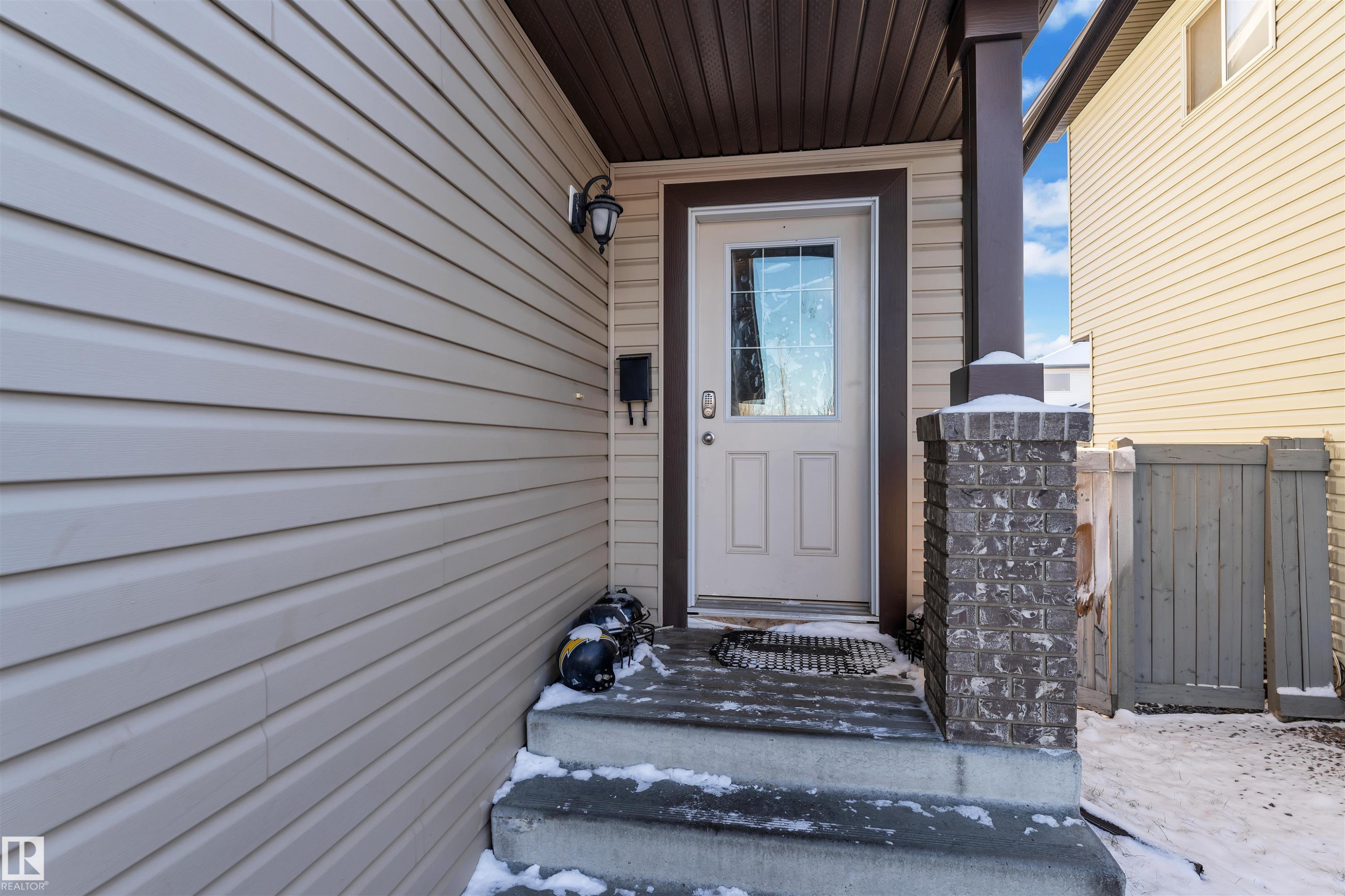 Snow covered property entrance with a gate - 3015 26 Ave Nw, Edmonton, AB - Outdoor With Exterior
