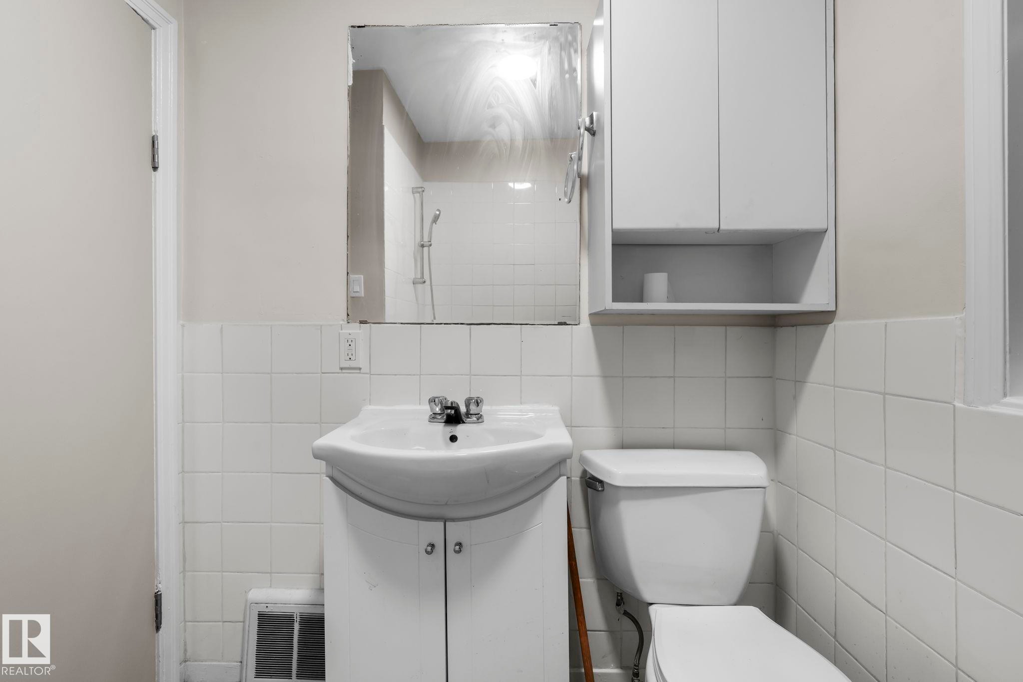 Full bath featuring tile walls, tiled shower, and vanity - Edmonton, AB - Indoor Photo Showing Bathroom
