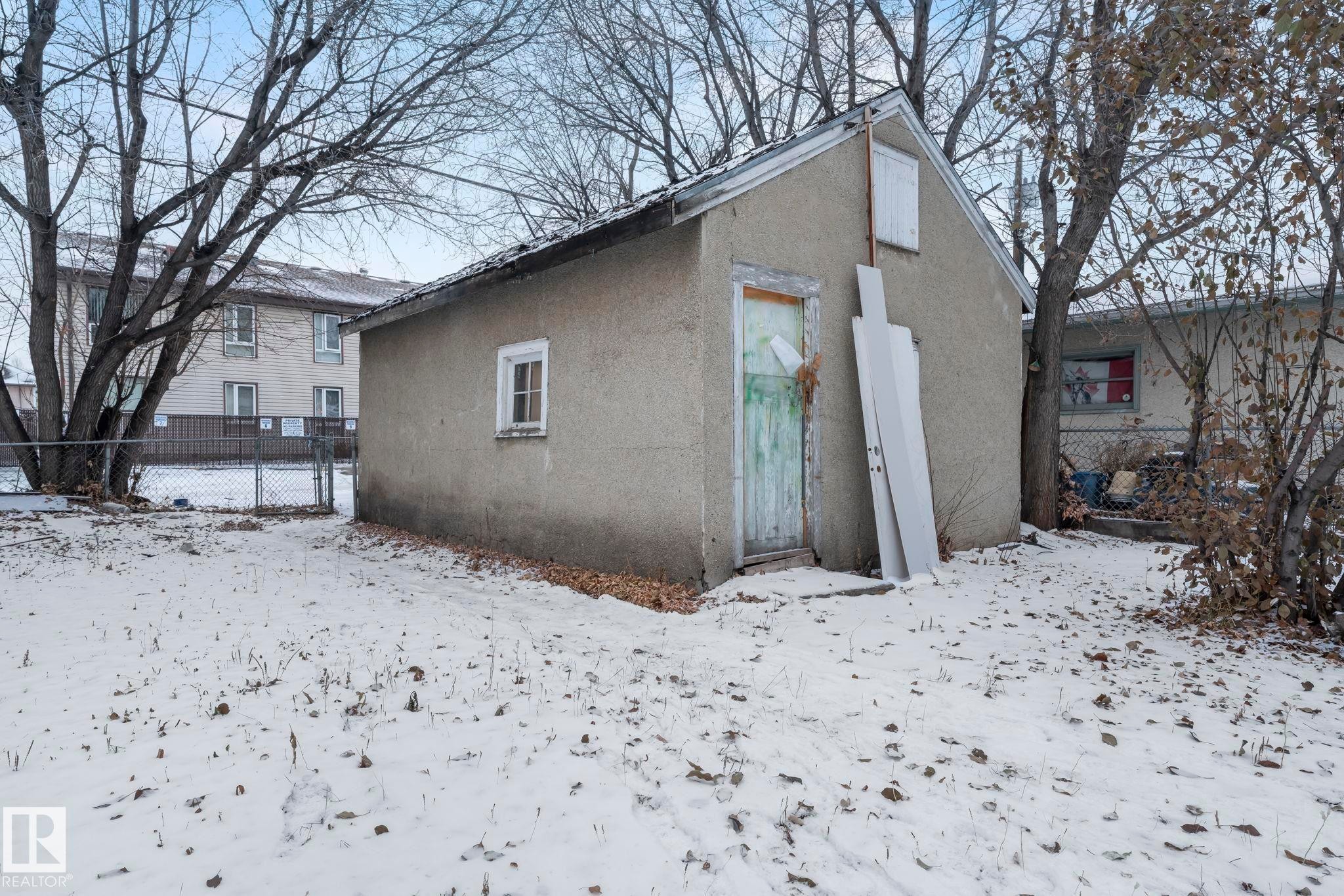 Snow covered rear of property featuring stucco siding - Edmonton, AB - Outdoor
