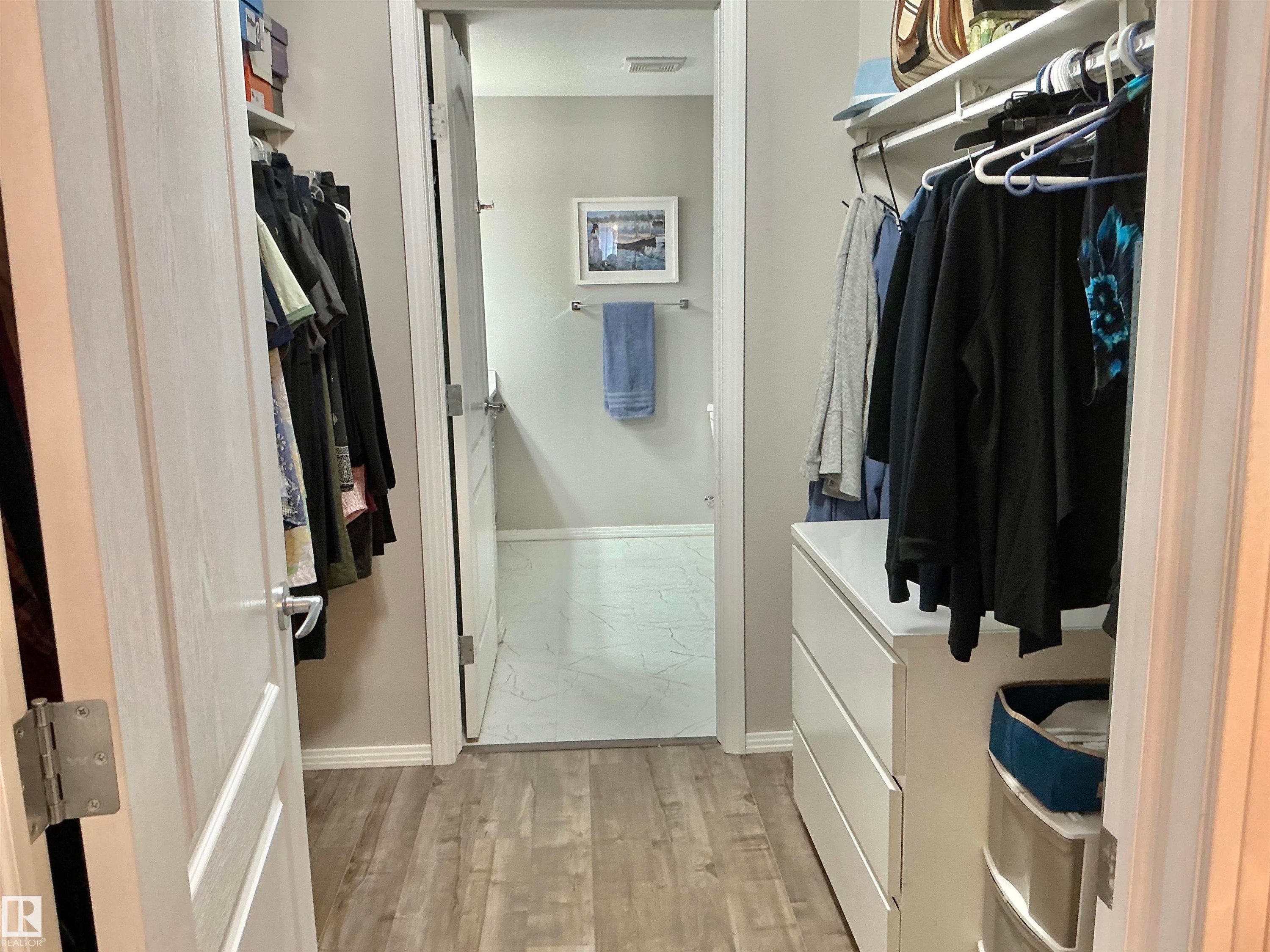 Walk thru Closet into bathroom - 135 592 Hooke Road, Edmonton, AB - Indoor With Storage