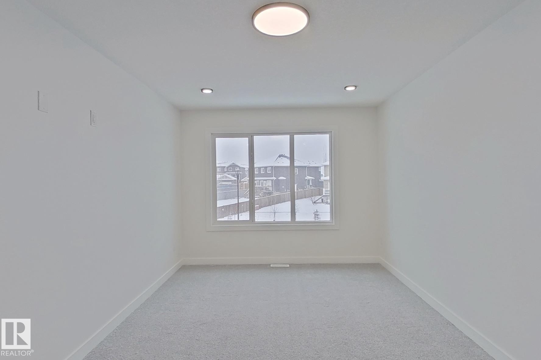 Spare room with baseboards and light colored carpet - 3158 Magpie Way, Edmonton, AB - Indoor Photo Showing Other Room