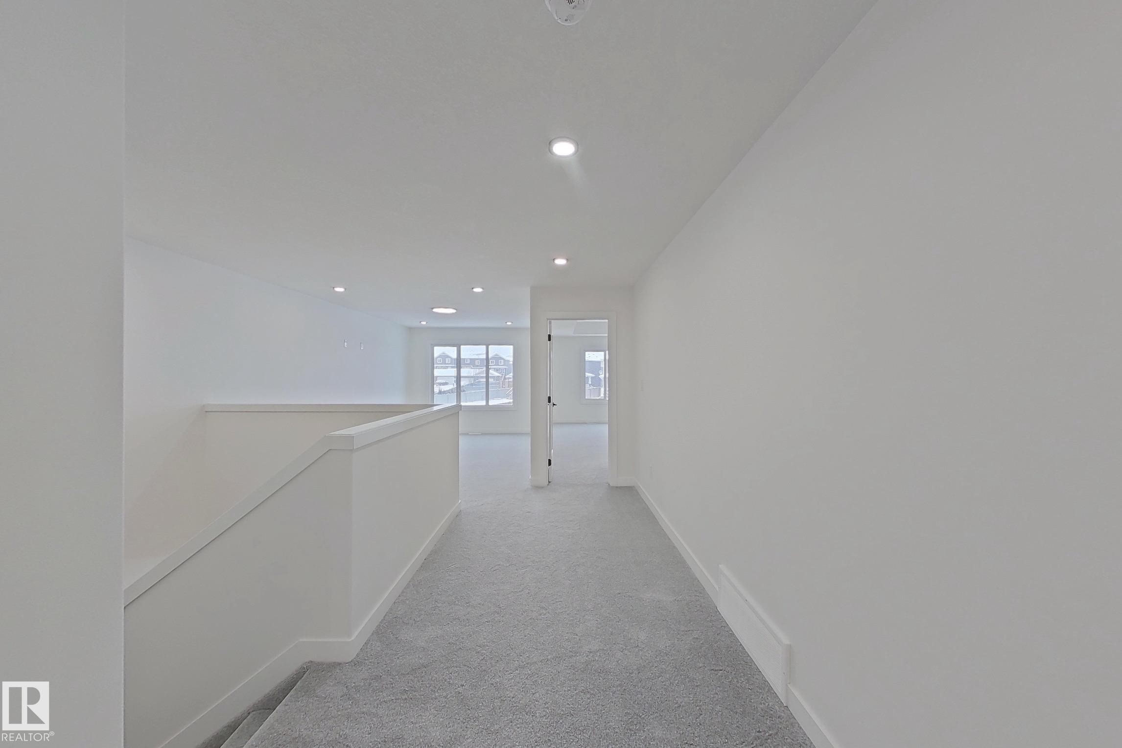 Corridor with an upstairs landing, recessed lighting, and light carpet - 3158 Magpie Way, Edmonton, AB - Indoor Photo Showing Other Room