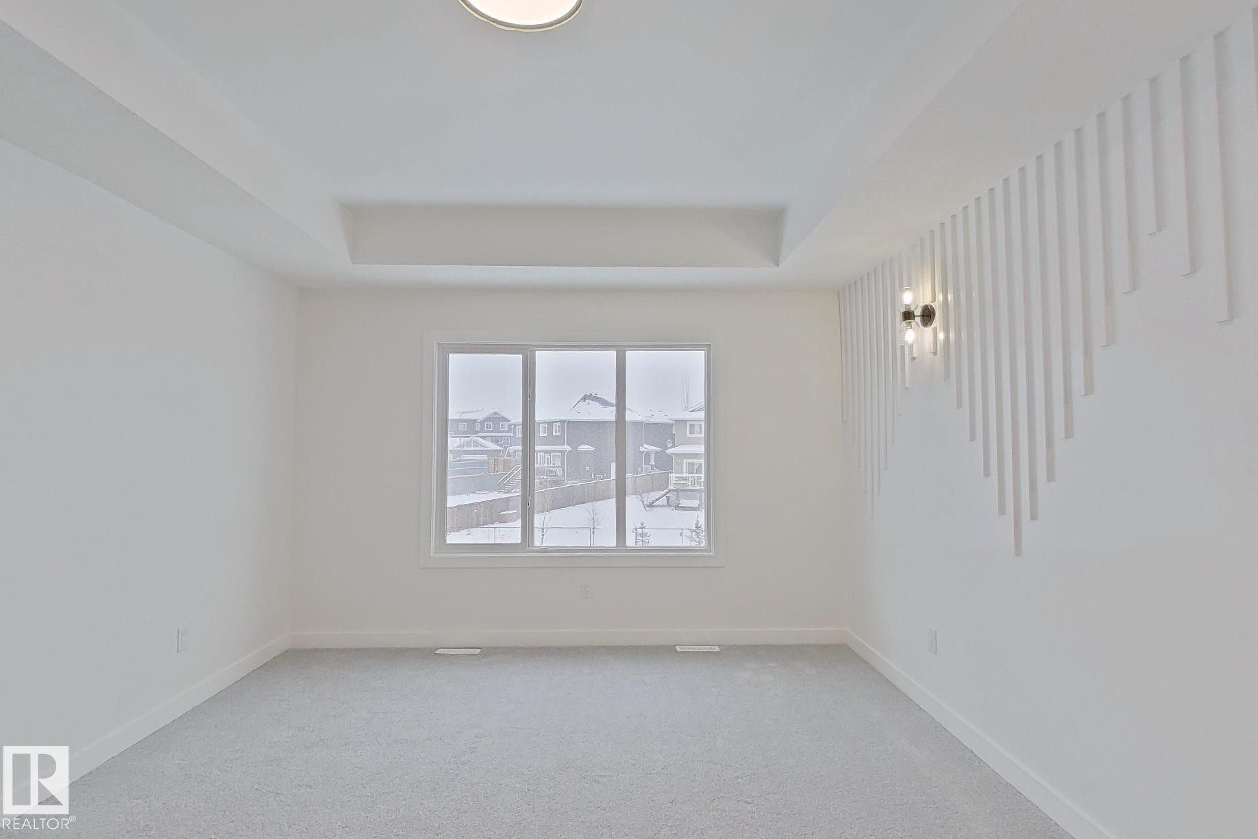 Carpeted spare room with a raised ceiling and baseboards - 3158 Magpie Way, Edmonton, AB - Indoor Photo Showing Other Room