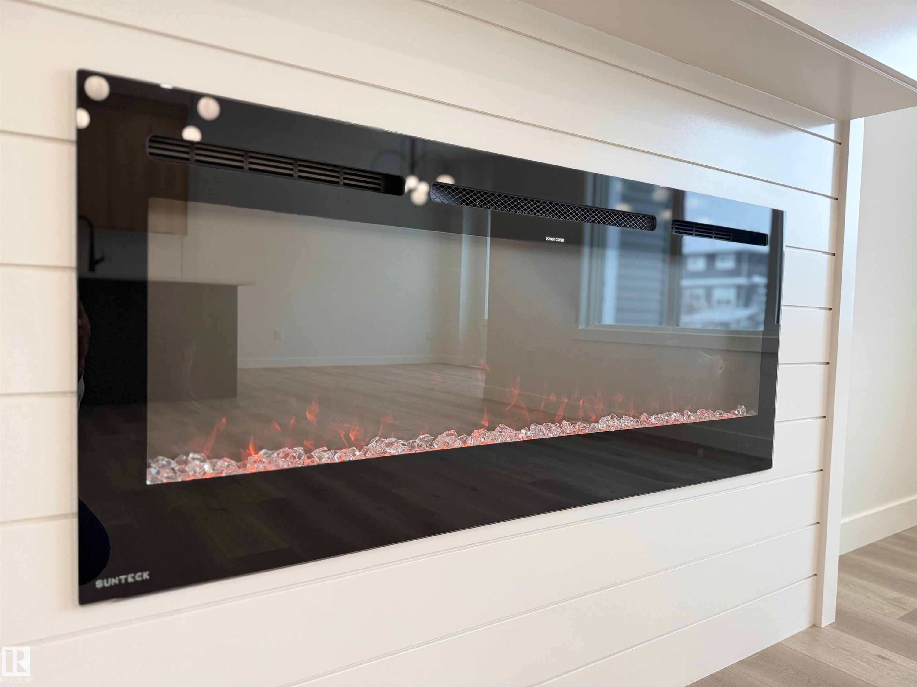 Detailed view of wood finished floors and baseboards - 3158 Magpie Way, Edmonton, AB - Indoor Photo Showing Other Room