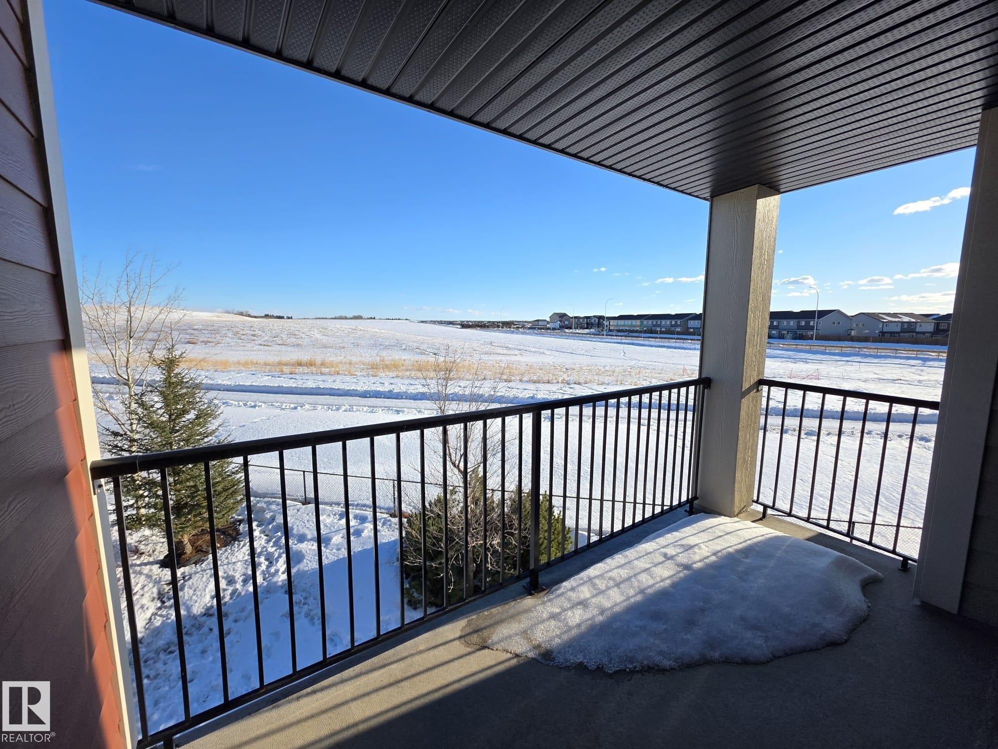 View of snow covered back of property - 313 1510 Watt Drive, Edmonton, AB - Outdoor With Body Of Water With Balcony With View With Exterior