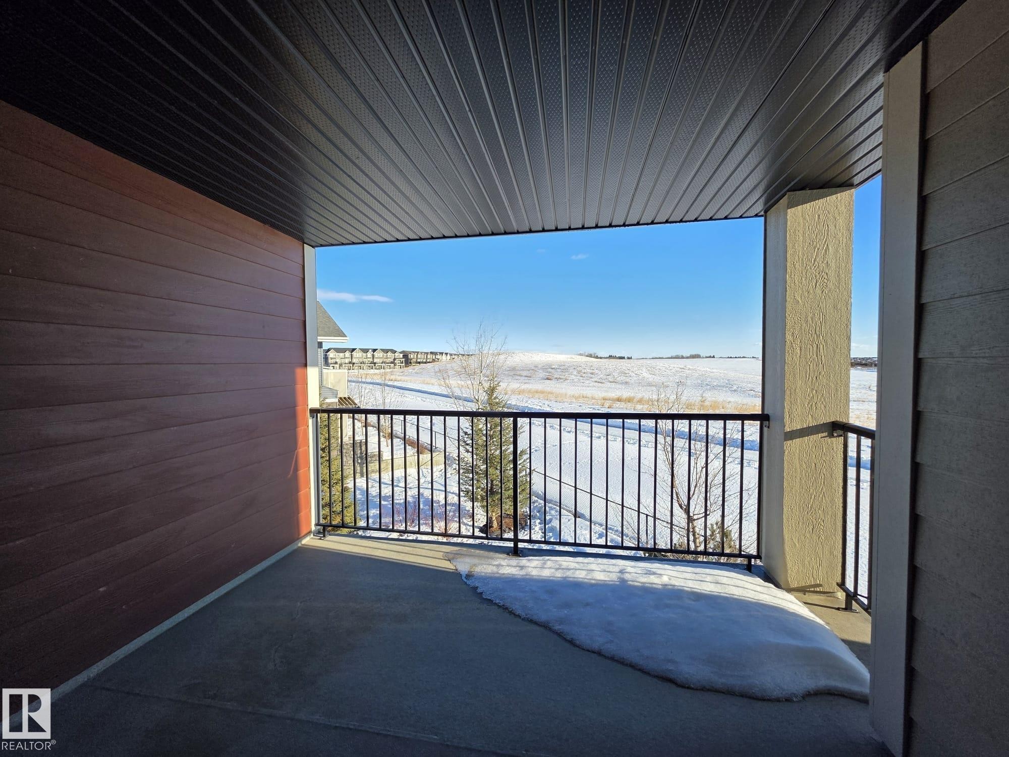 View of snow covered back of property - 313 1510 Watt Drive, Edmonton, AB - Outdoor With Balcony With Exterior
