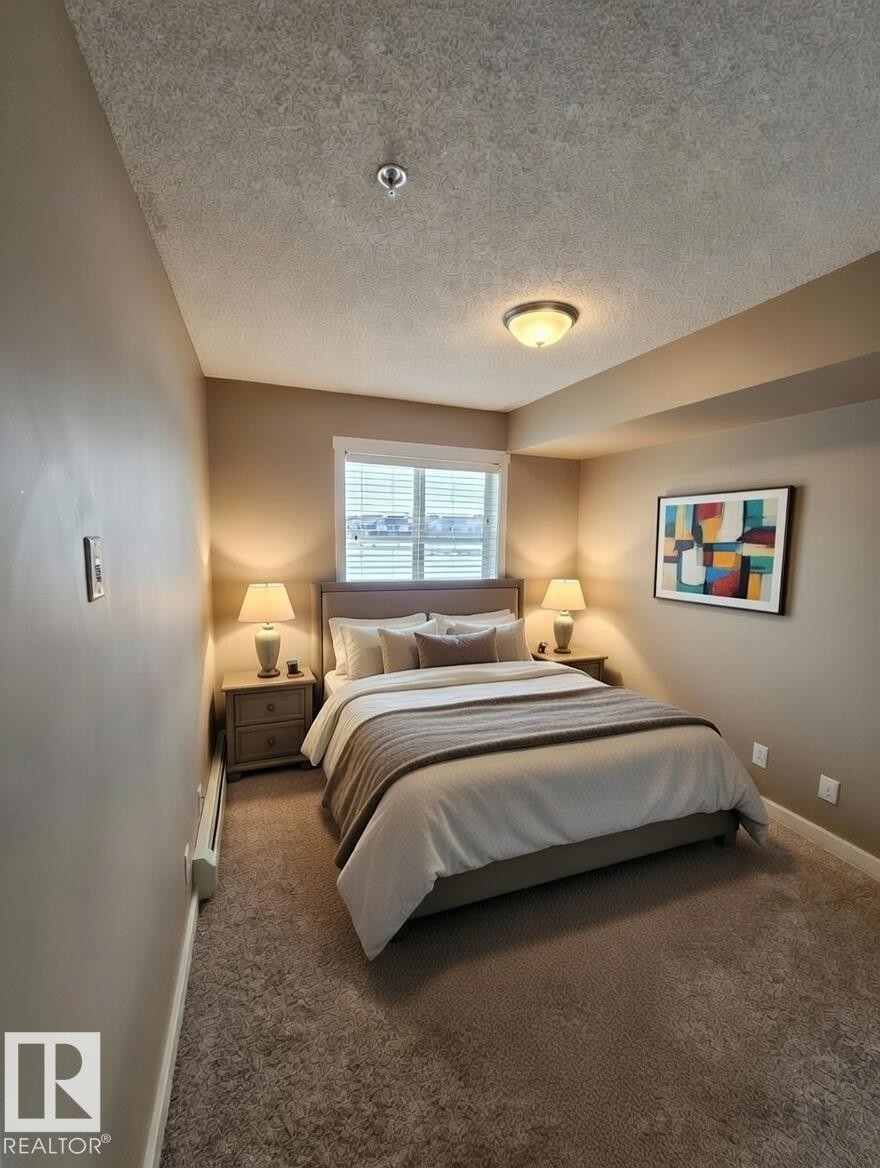 Carpeted bedroom featuring a textured ceiling and baseboard heating - 313 1510 Watt Drive, Edmonton, AB - Indoor Photo Showing Bedroom