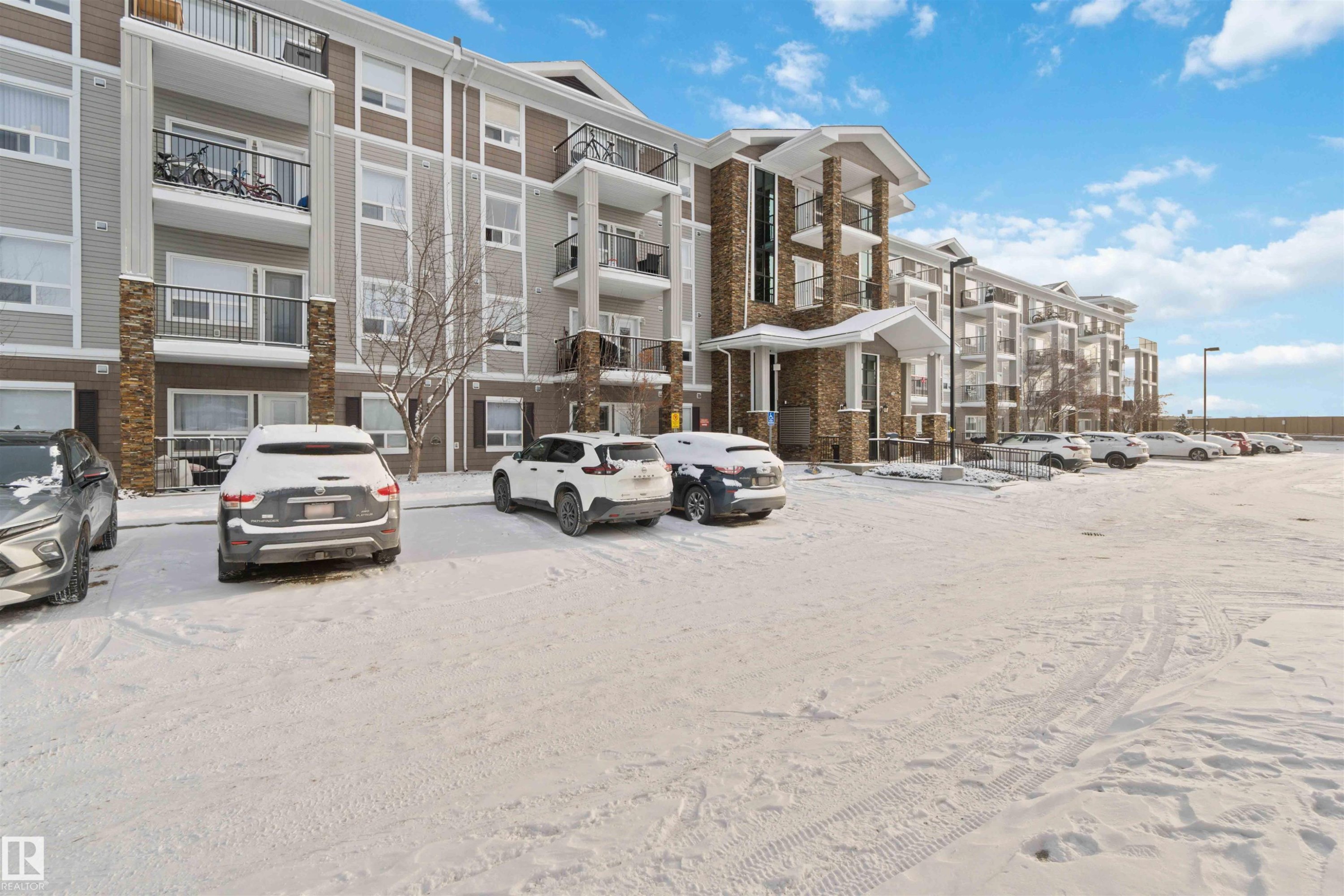 View of apartment building / complex featuring uncovered parking - 2117 9357 Simpson Drive, Edmonton, AB - Outdoor With Balcony With Facade