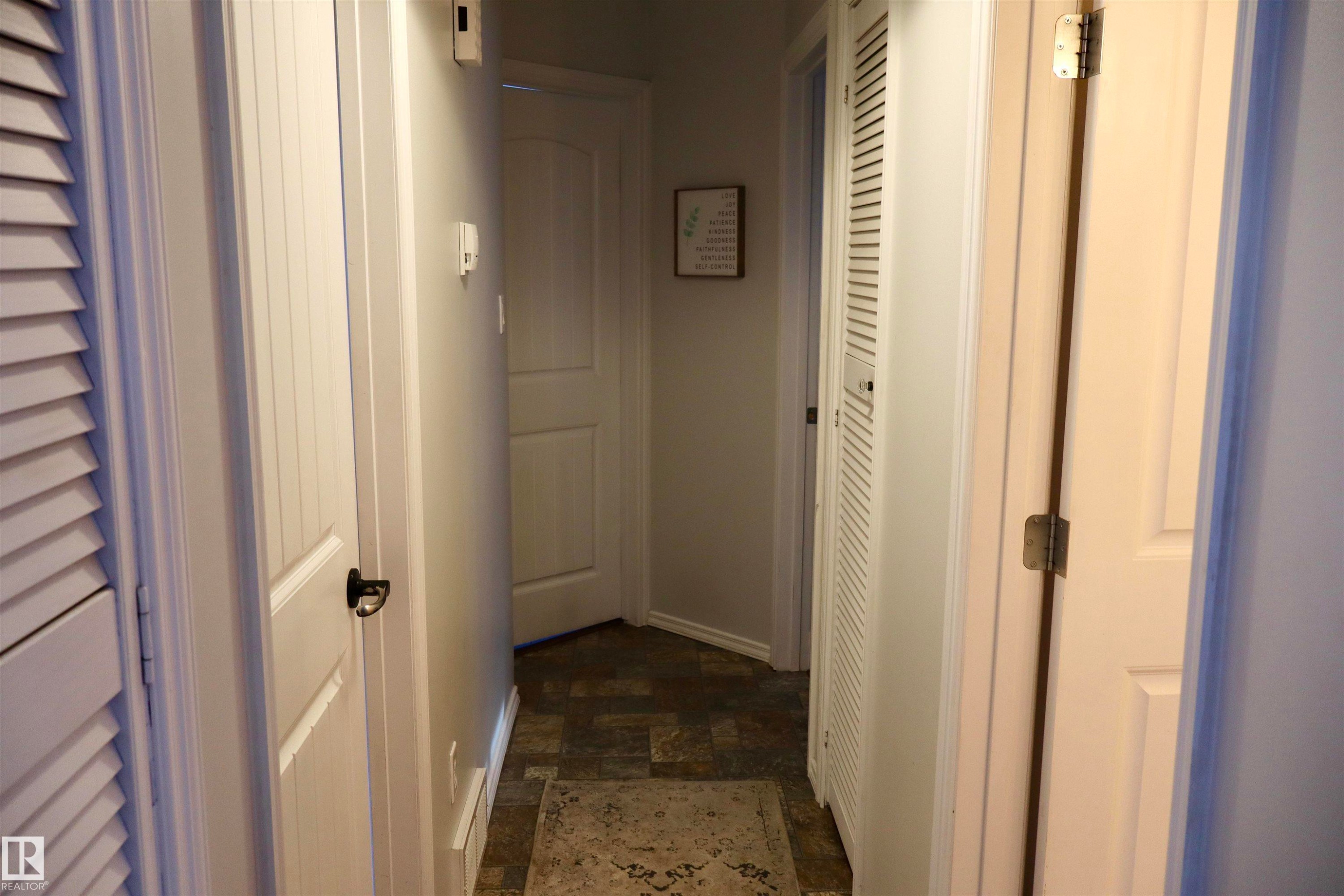 Hallway with stone finish floors and baseboards - 4505 58 Avenue, Barrhead, AB - Indoor Photo Showing Other Room
