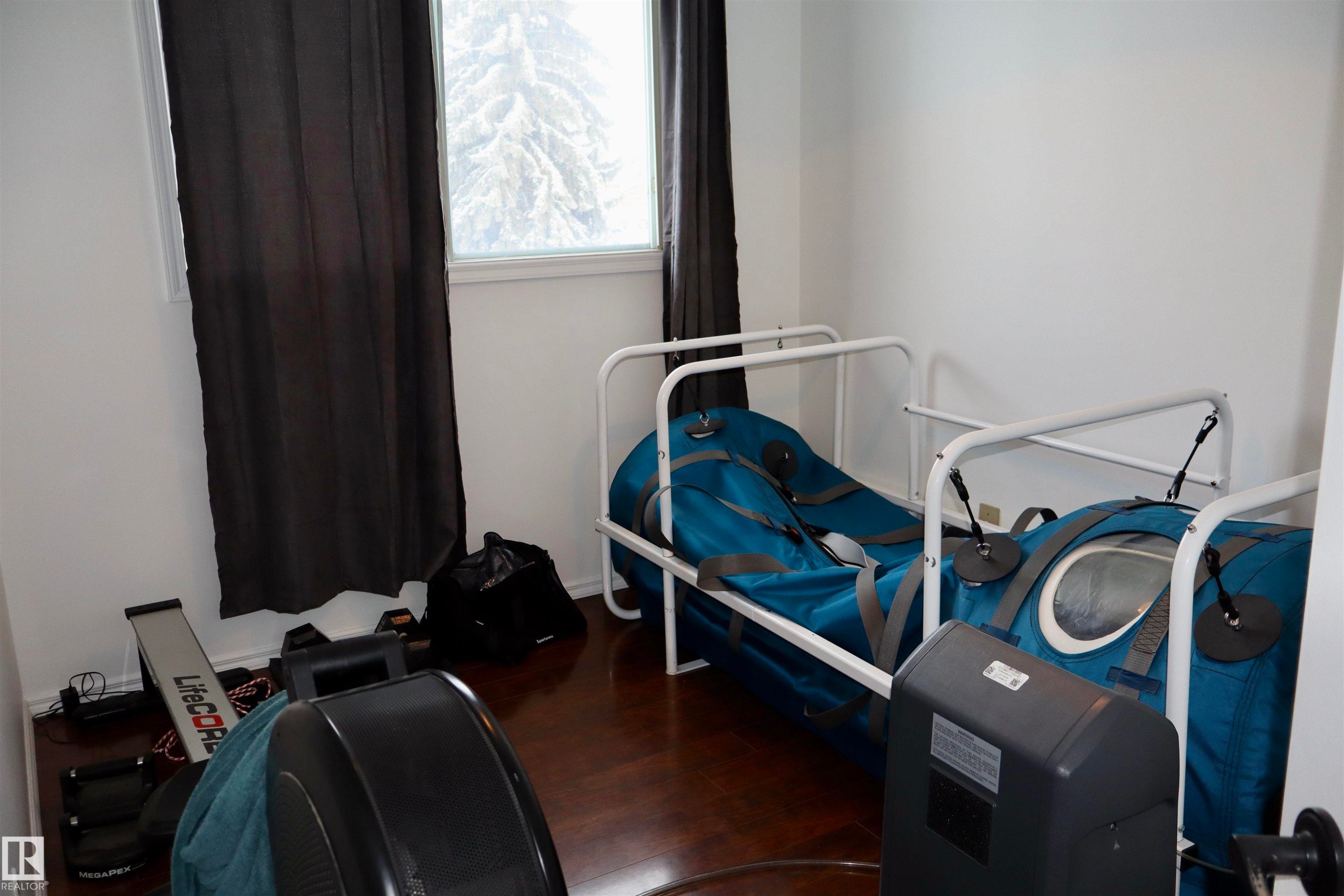 Workout room featuring dark wood-style flooring - 4505 58 Avenue, Barrhead, AB - Indoor
