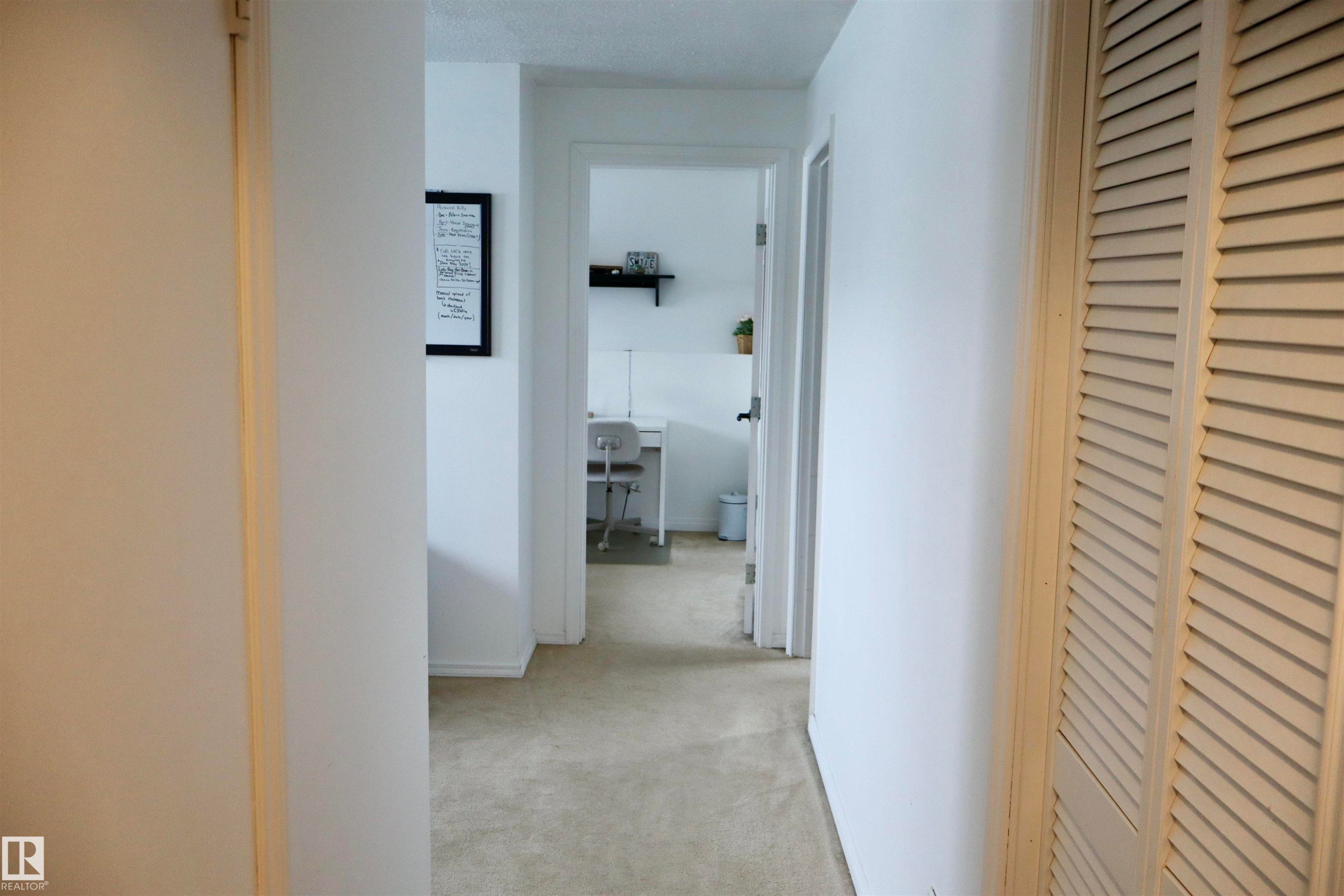 Hallway featuring light colored carpet - 4505 58 Avenue, Barrhead, AB - Indoor Photo Showing Other Room
