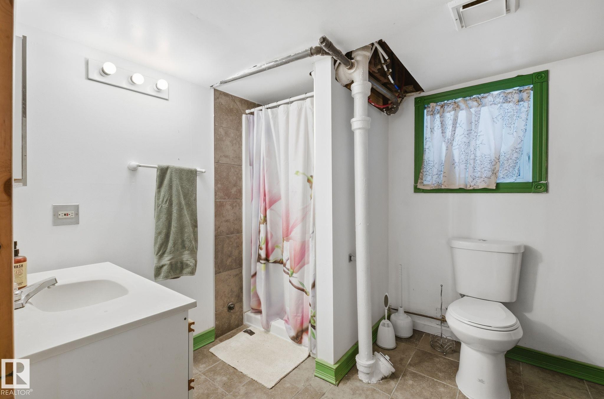 Bathroom featuring a stall shower, vanity, and tile patterned flooring - 9705 87 Avenue, Edmonton, AB - Indoor Photo Showing Bathroom
