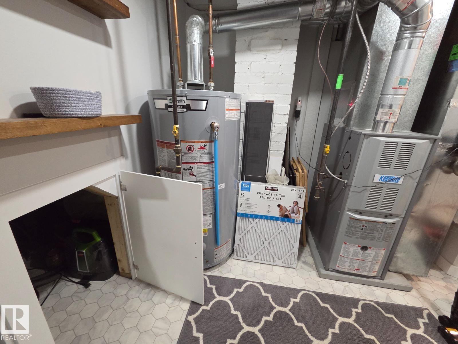 Utilities with gas water heater and heating unit - 12410 120 Avenue, Edmonton, AB - Indoor Photo Showing Basement