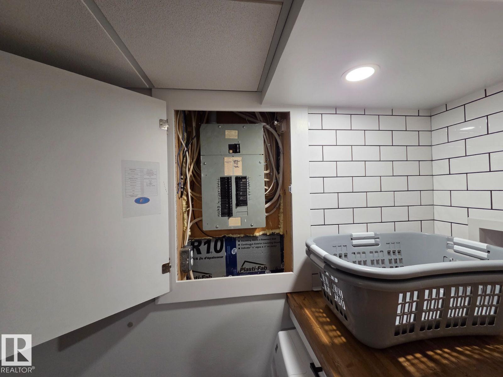 Interior space with electric panel and tile walls - 12410 120 Avenue, Edmonton, AB - Indoor