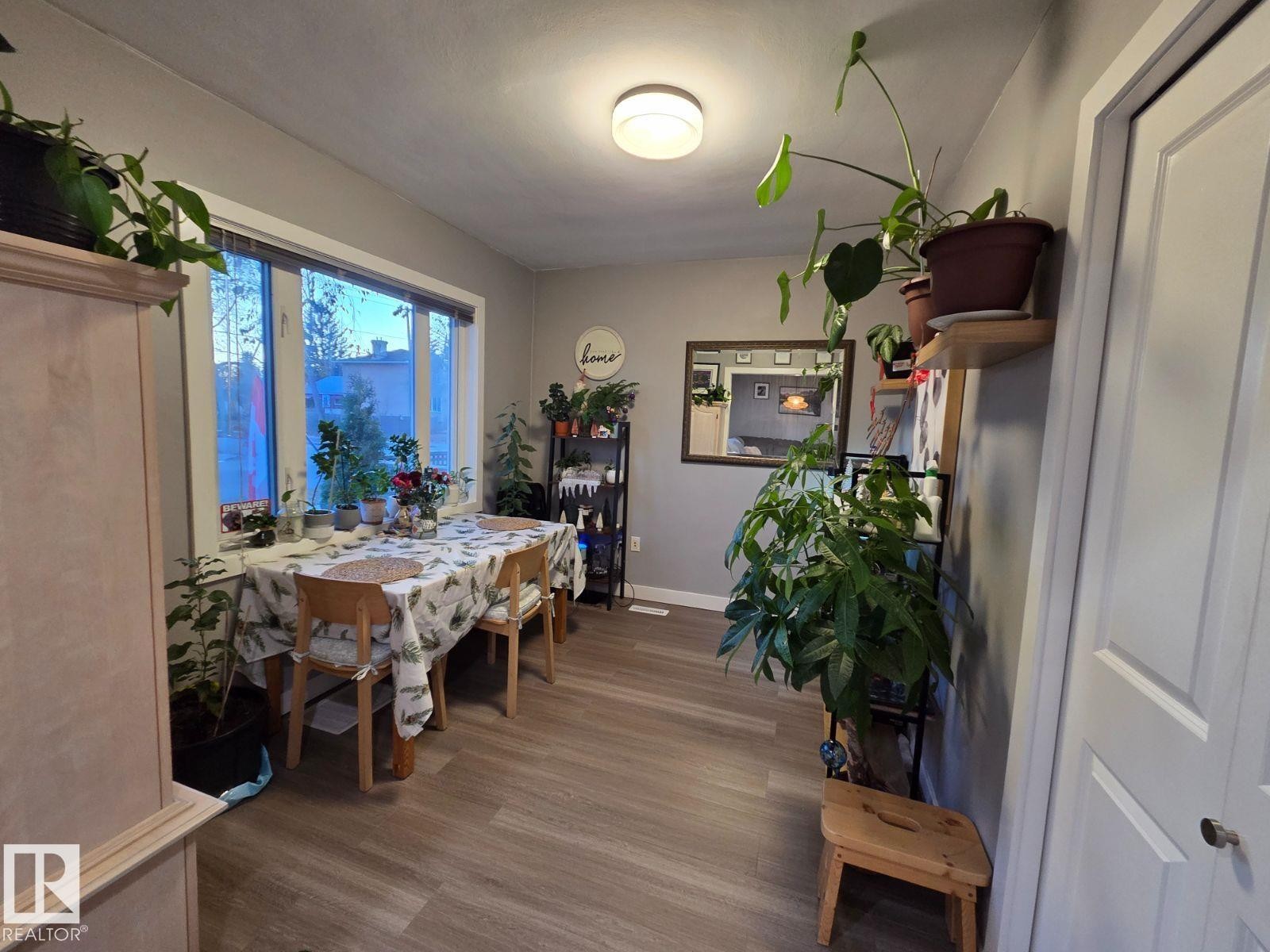 Dining room with dark wood-type flooring and baseboards - 12410 120 Avenue, Edmonton, AB - Indoor Photo Showing Dining Room