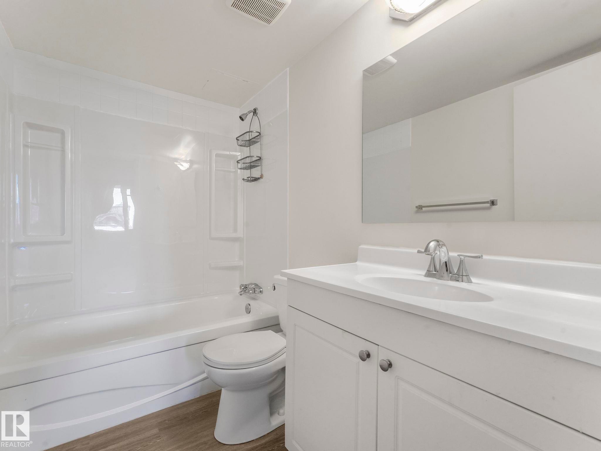 new tub surround, flooring and vanity - 406 10125 109 Street, Edmonton, AB - Indoor Photo Showing Bathroom