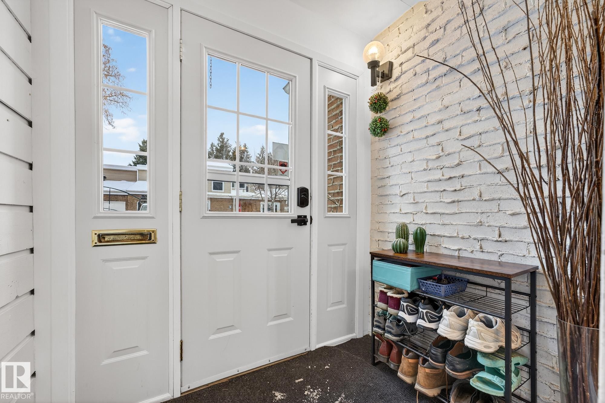 Doorway to outside with brick wall and carpet - 7 Grandview Ridge, St. Albert, AB - Indoor Photo Showing Other Room