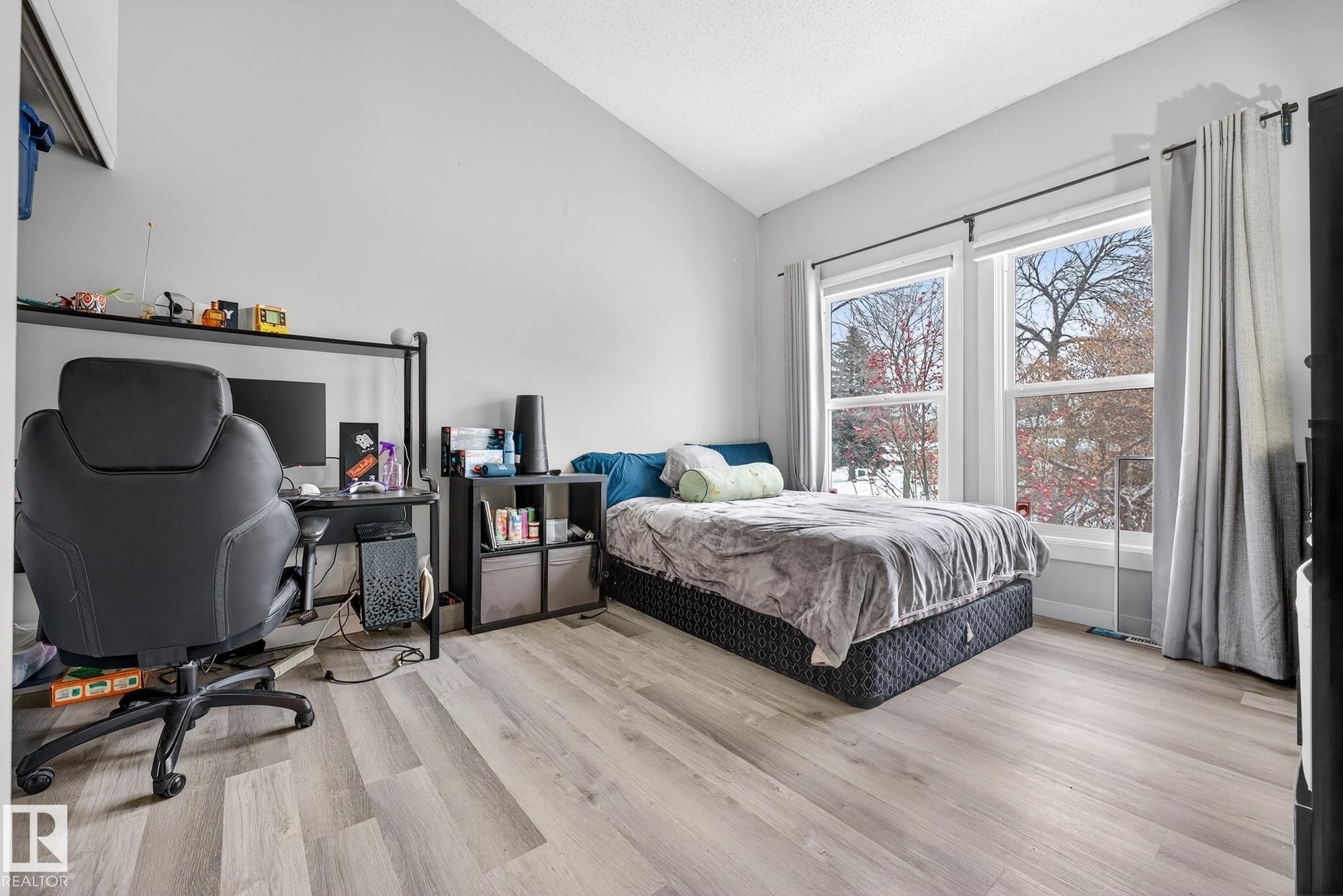 Bedroom featuring lofted ceiling, light wood-type flooring, and a desk - 7 Grandview Ridge, St. Albert, AB - Indoor Photo Showing Bedroom