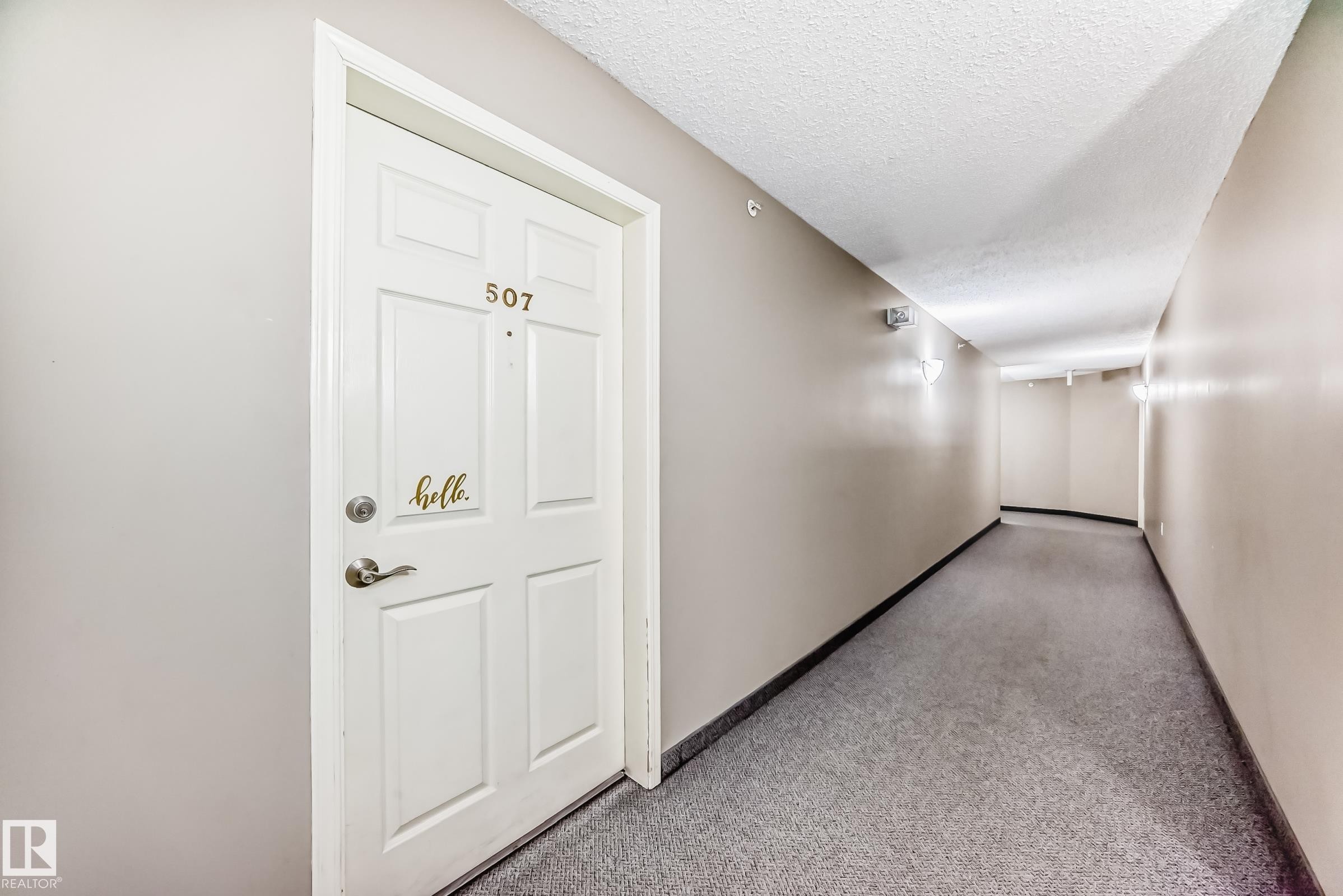 Corridor with a textured ceiling and carpet - 507 11716 100 Avenue, Edmonton, AB - Indoor Photo Showing Other Room