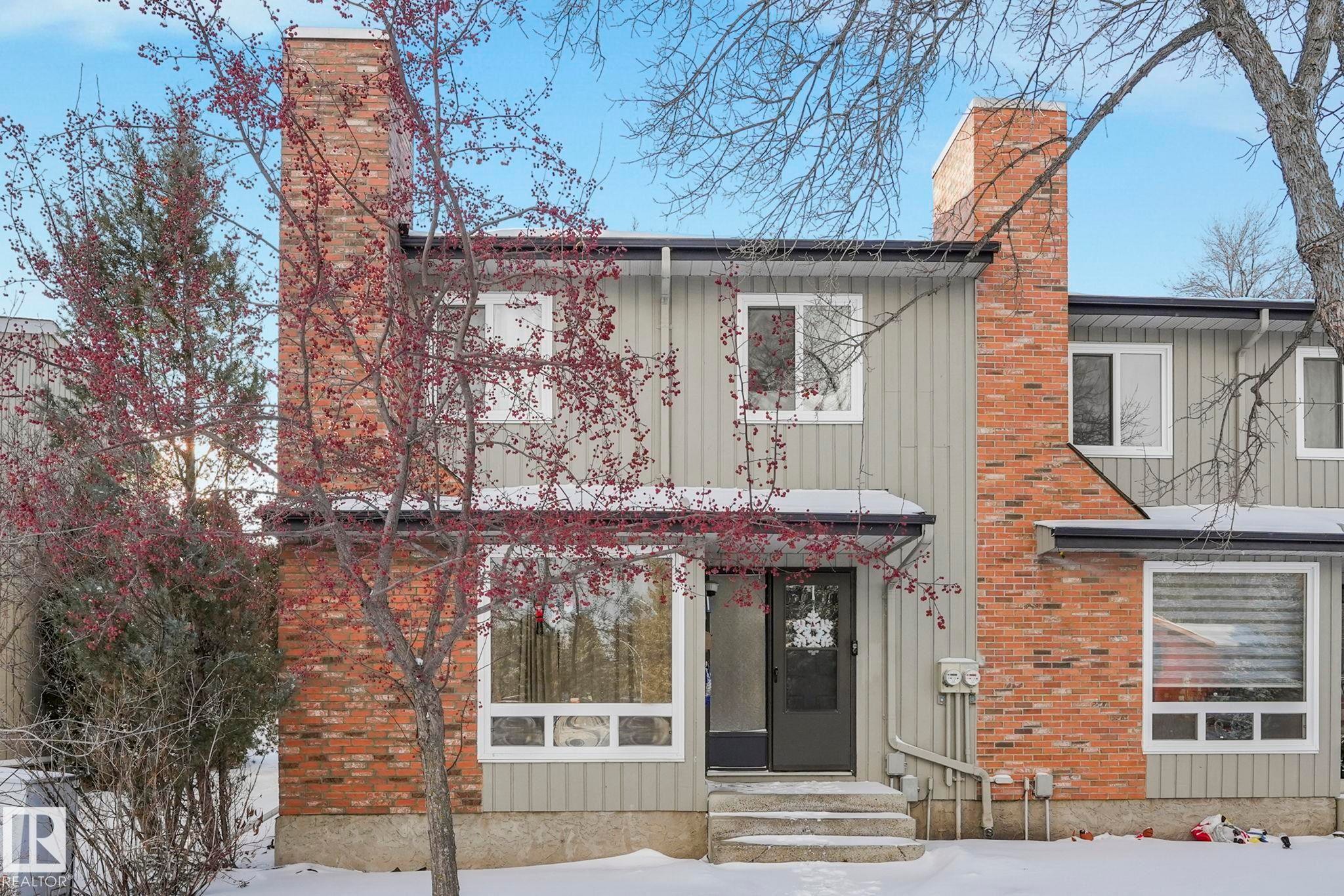 View of front of property with a chimney, board and batten siding, entry steps, and brick siding - 11811 32A Avenue, Edmonton, AB - Outdoor