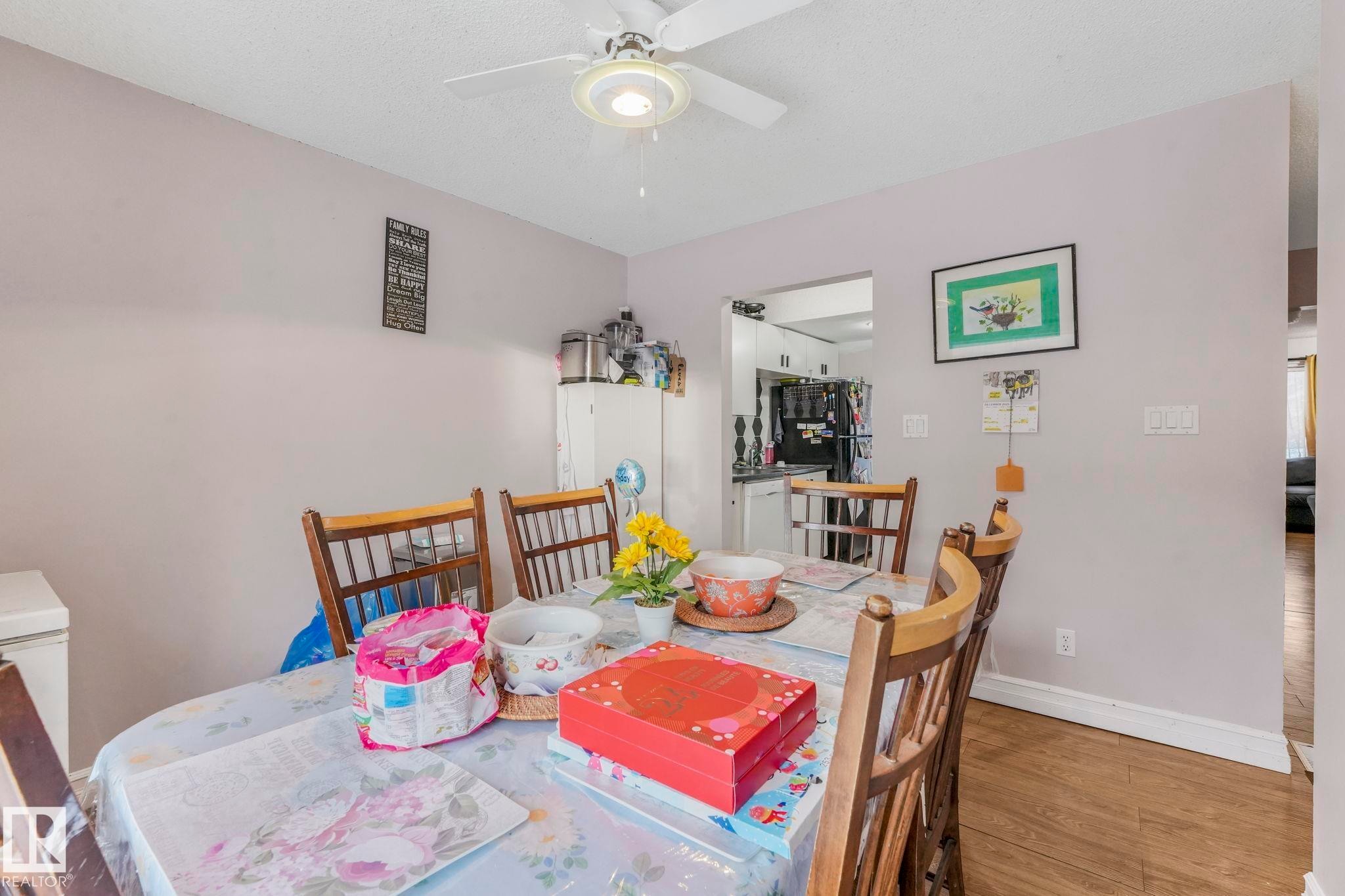 Dining area with wood finished floors and ceiling fan - 11811 32A Avenue, Edmonton, AB - Indoor Photo Showing Dining Room