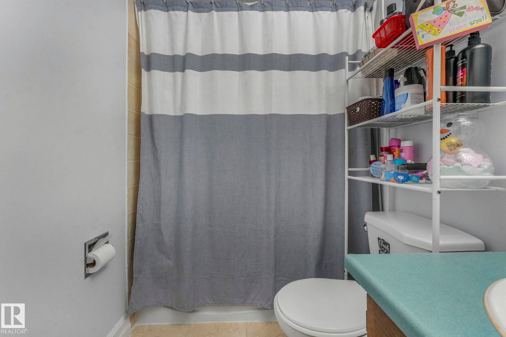 Bathroom with vanity and tile patterned floors - 11811 32A Avenue, Edmonton, AB - Indoor Photo Showing Bathroom