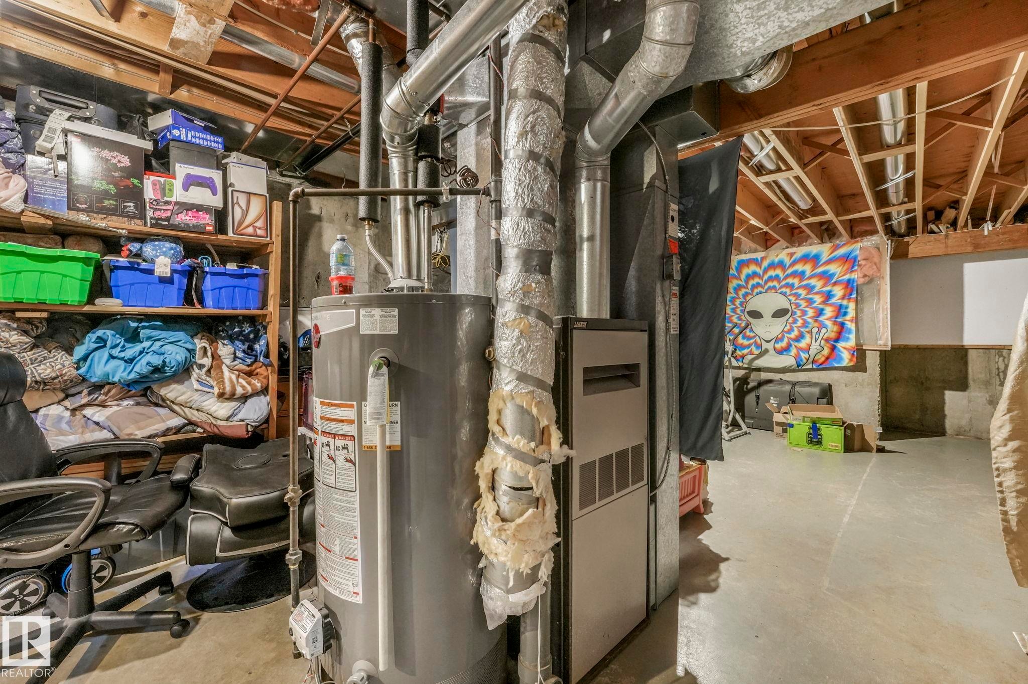Utilities with water heater - 11811 32A Avenue, Edmonton, AB - Indoor Photo Showing Basement