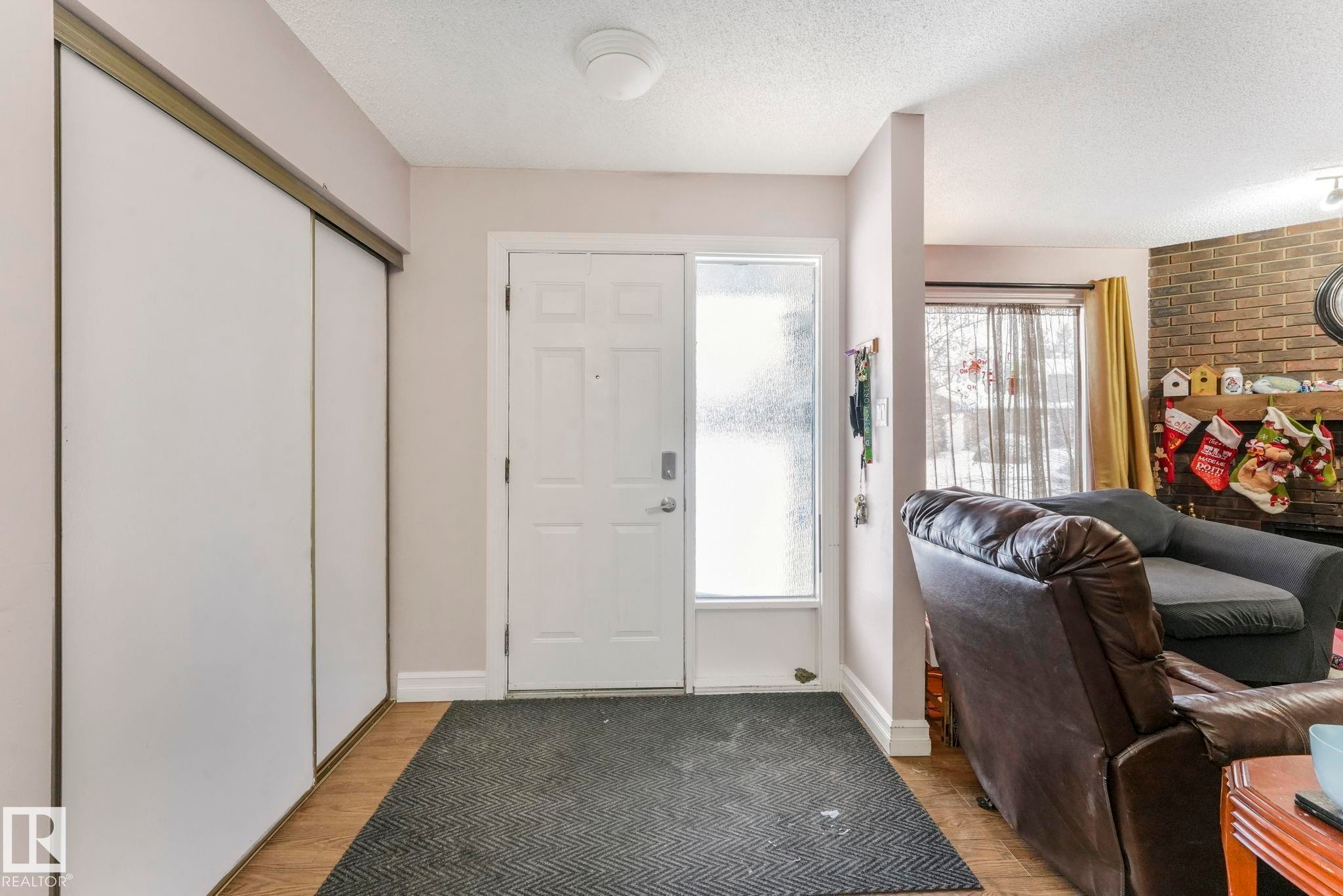 Entryway with light wood finished floors and a textured ceiling - 11811 32A Avenue, Edmonton, AB - Indoor Photo Showing Other Room