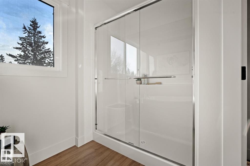 Bathroom featuring a stall shower and wood finished floors - 24 Grayson Green, Stony Plain, AB - Indoor Photo Showing Other Room