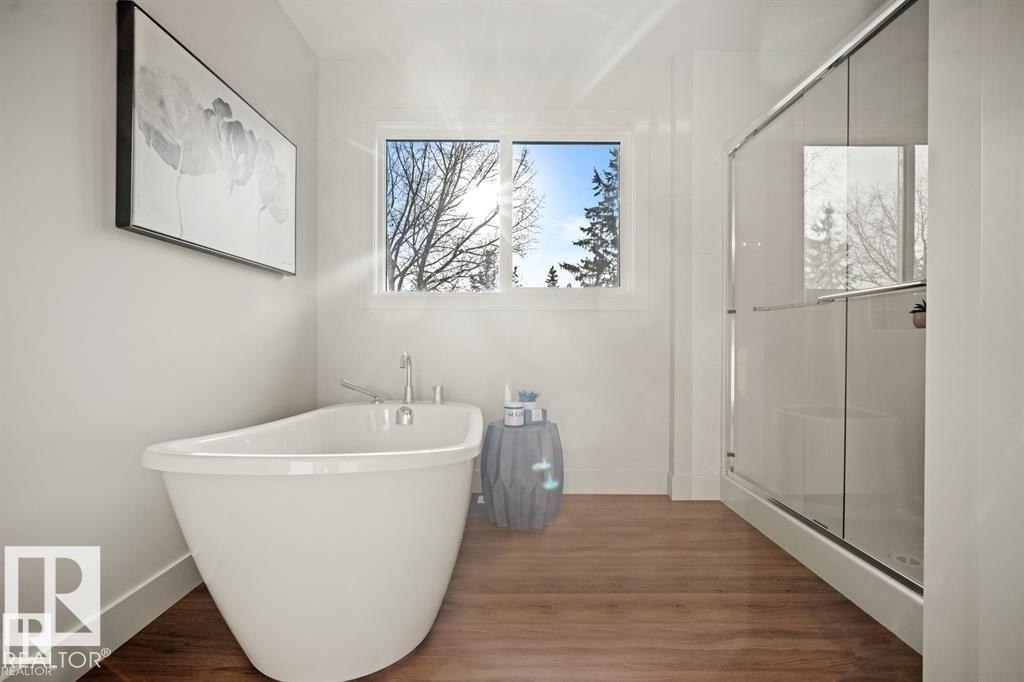 Bathroom featuring a shower stall, dark wood finished floors, and a freestanding tub - 24 Grayson Green, Stony Plain, AB - Indoor Photo Showing Bathroom