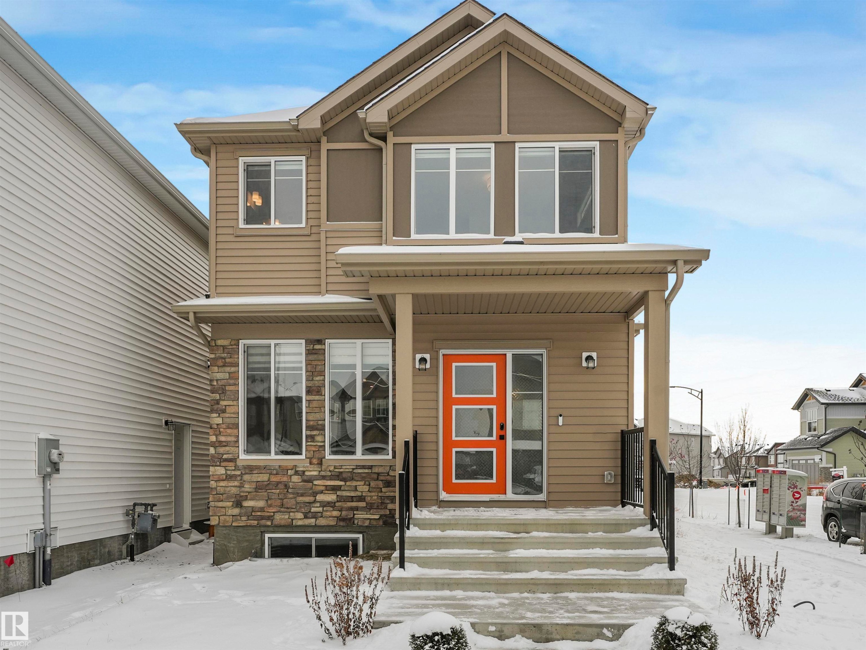 View of front of property with stone siding and covered porch - 4447 Kinsella Green, Edmonton, AB - Outdoor