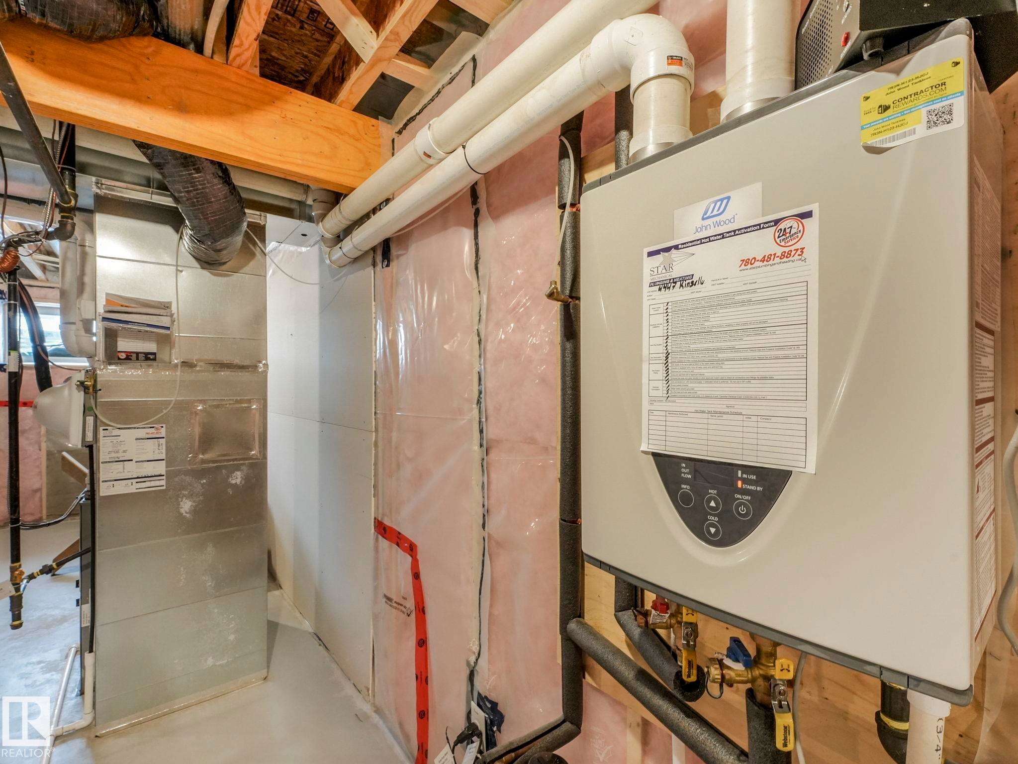 Utilities featuring water heater and heating unit - 4447 Kinsella Green, Edmonton, AB - Indoor Photo Showing Basement