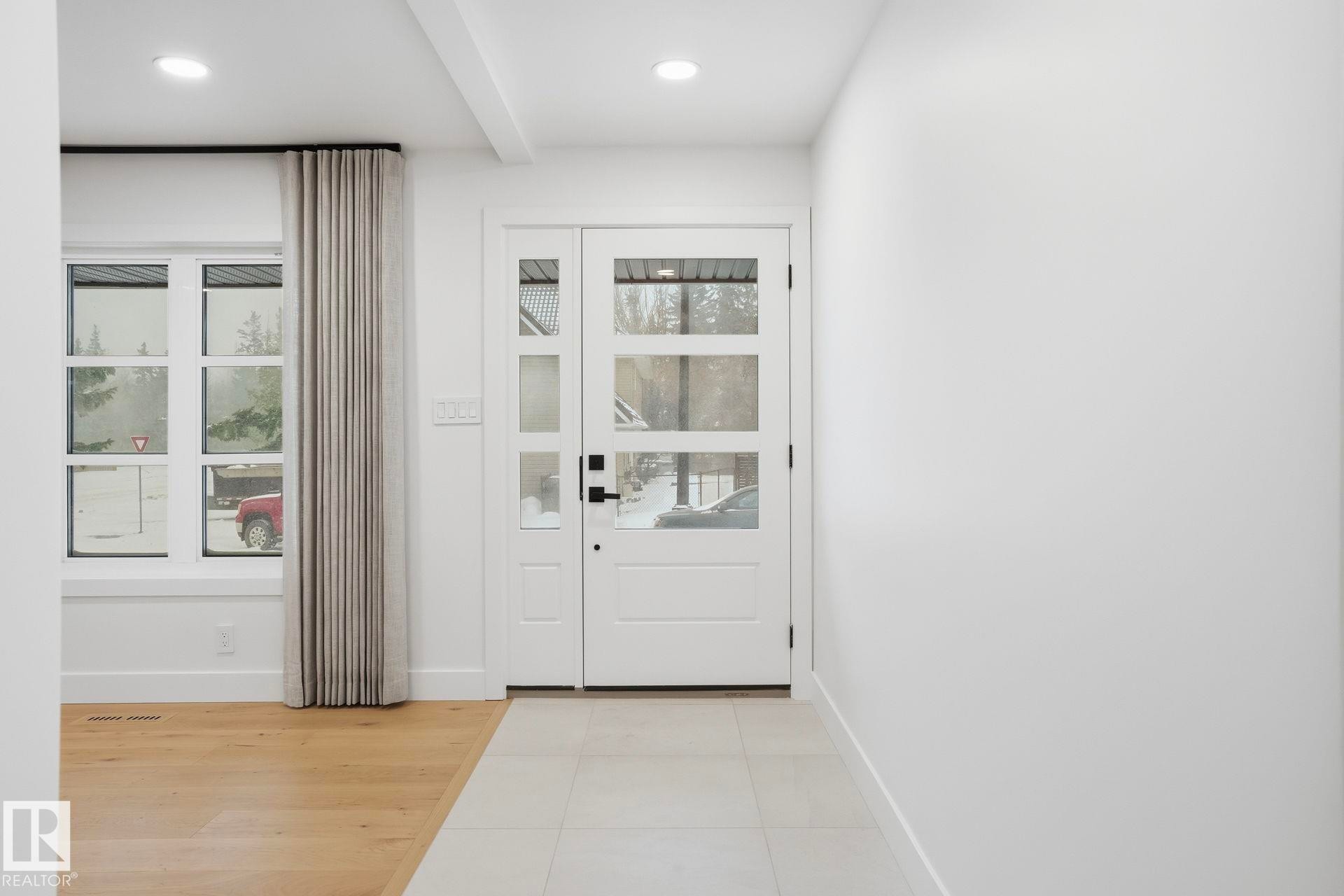 Doorway to outside featuring wood finished floors, recessed lighting, plenty of natural light, and beam ceiling - 14604 Mackenzie Drive, Edmonton, AB - Indoor Photo Showing Other Room