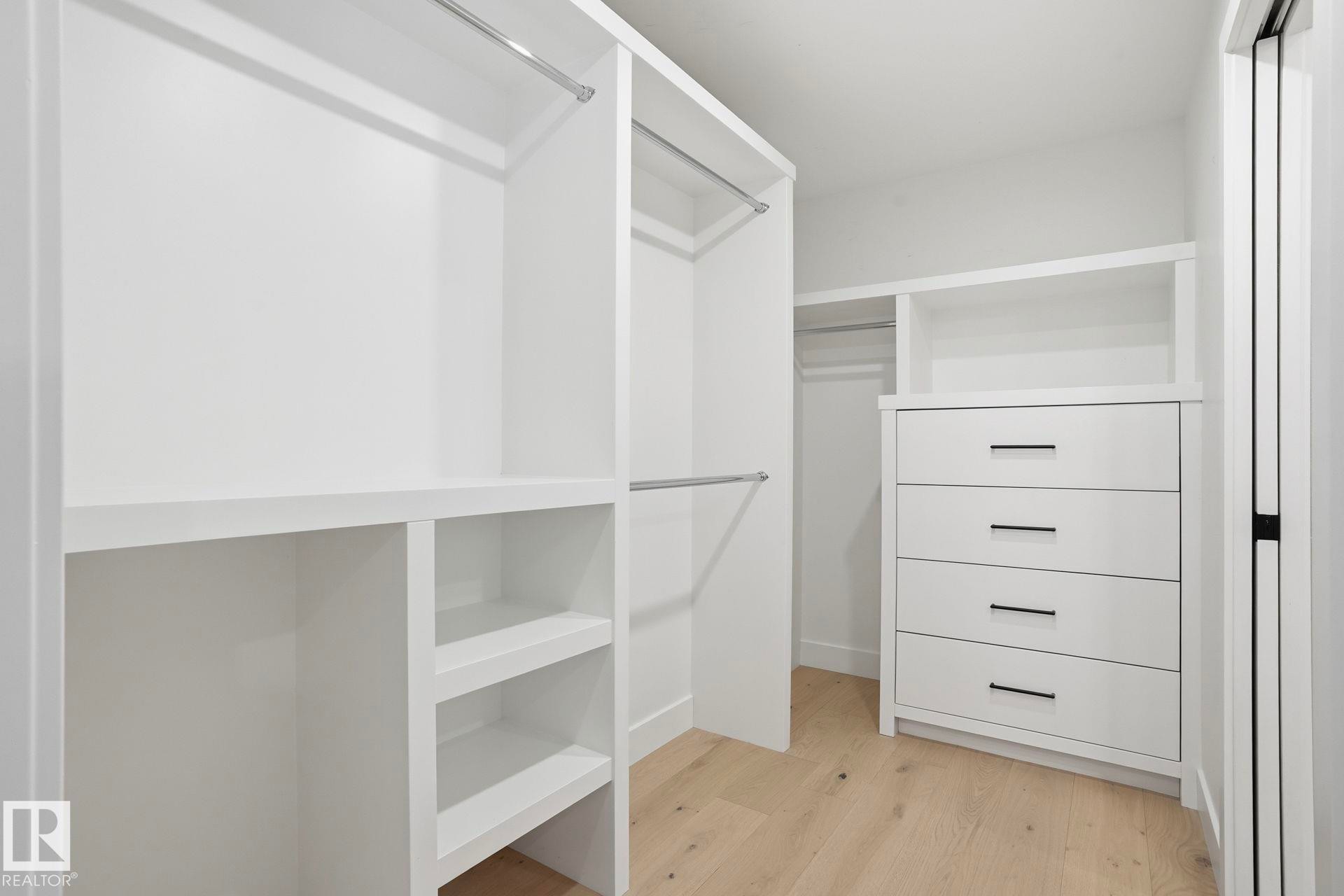 Spacious closet featuring light wood-style floors - 14604 Mackenzie Drive, Edmonton, AB - Indoor With Storage