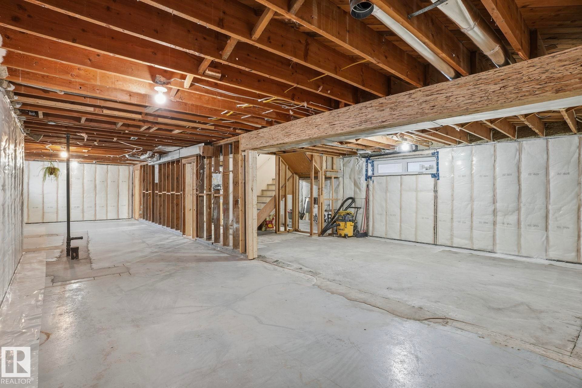 Unfinished below grade area with stairway - 14604 Mackenzie Drive, Edmonton, AB - Indoor Photo Showing Basement