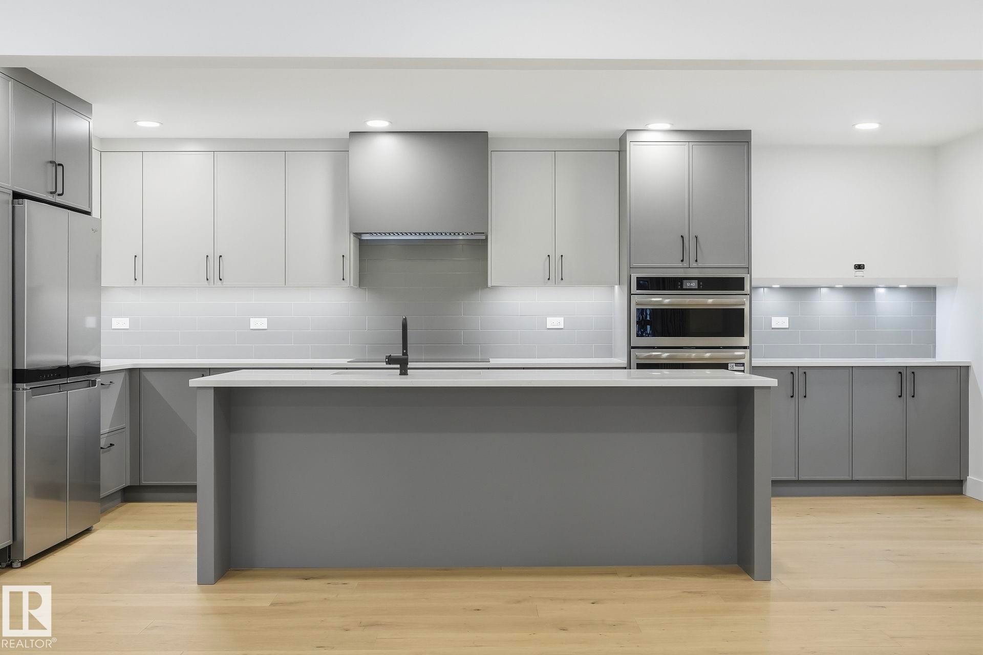 Kitchen with gray cabinets, stainless steel appliances, tasteful backsplash, a kitchen island with sink, and recessed lighting - 14604 Mackenzie Drive, Edmonton, AB - Indoor Photo Showing Kitchen With Upgraded Kitchen